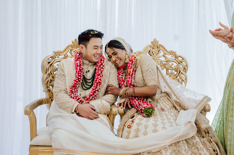 I first crossed paths with Xavier a few years back at Danny and Andy's wedding, where he stood as one of the groomsmen at The Ryland Inn in 2021. When Xavier and Priya's own wedding day approached, I was deeply honored that he remembered me and reached out to discuss capturing their special day. Meeting Priya and Xavier together during their engagement session in Princeton, NJ was an essential part of my process. It allowed me to delve into their personalities and witness the beautiful chemistry they shared. Engagements sessions, for me, serve as a cornerstone in establishing a genuine connection with my couples before the main event. Priya and Xavier both started the wedding day at the Hyatt Regency in Jersey City, a venue boasting panoramic views of the Hudson River and the iconic Manhattan skyline. Against this breathtaking backdrop, they readied themselves, shared a heartwarming first look along the Hudson River Waterfront Walkway, then shortly after Priya and Xavier's family and friends joined them for photos. As Priya watched from a balcony, Xavier's Baraat procession unfolded below, a lively affair marked by music, drums, and joyous celebrations. Following the Baraat wedding guests ascended to the wedding ceremony room at the Hyatt Regency, where a beautifully adorned Mandap awaited their union. The cocktail hour tantalized guests with an array of delicious Indian cuisine, setting the stage for the grand entrance into the candlelit reception hall. Priya and Xavier stepped in, resplendent in their evening attire, launching into their first dance. This was followed by the traditional Filipino money dance, Throughout the evening, dance performances, heartfelt parent dances, and touching speeches filled the air with love and laughter. Priya and Xavier's faces radiated with pure joy, reflecting the love that enveloped them on their special day. Priya and Xavier Hyatt Regency Jersey City NJ wedding documented by by Karis | Hey Karis | Destination Wedding Photographer | Manhattan, Catskills, Hudson Valley, Brooklyn and NJ | Destination Elopement, Destination Wedding Photographer | Hey Karis is fun documentary wedding and elopement photographer based in NY, NJ.