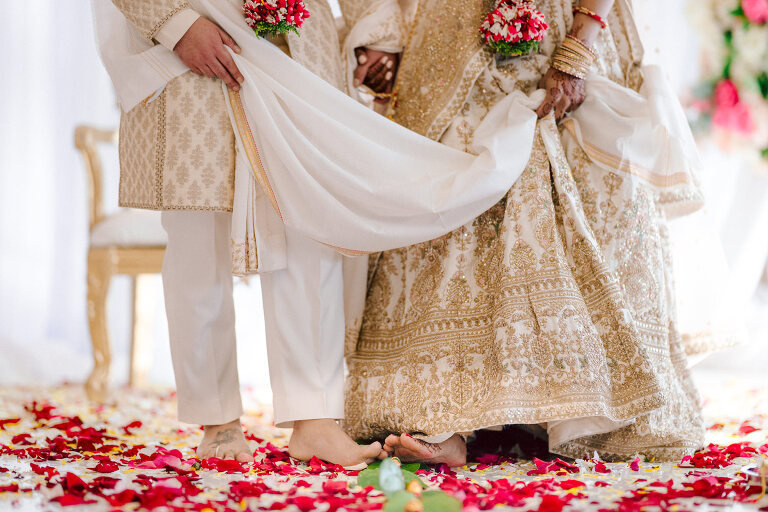 I first crossed paths with Xavier a few years back at Danny and Andy's wedding, where he stood as one of the groomsmen at The Ryland Inn in 2021. When Xavier and Priya's own wedding day approached, I was deeply honored that he remembered me and reached out to discuss capturing their special day. Meeting Priya and Xavier together during their engagement session in Princeton, NJ was an essential part of my process. It allowed me to delve into their personalities and witness the beautiful chemistry they shared. Engagements sessions, for me, serve as a cornerstone in establishing a genuine connection with my couples before the main event. Priya and Xavier both started the wedding day at the Hyatt Regency in Jersey City, a venue boasting panoramic views of the Hudson River and the iconic Manhattan skyline. Against this breathtaking backdrop, they readied themselves, shared a heartwarming first look along the Hudson River Waterfront Walkway, then shortly after Priya and Xavier's family and friends joined them for photos. As Priya watched from a balcony, Xavier's Baraat procession unfolded below, a lively affair marked by music, drums, and joyous celebrations. Following the Baraat wedding guests ascended to the wedding ceremony room at the Hyatt Regency, where a beautifully adorned Mandap awaited their union. The cocktail hour tantalized guests with an array of delicious Indian cuisine, setting the stage for the grand entrance into the candlelit reception hall. Priya and Xavier stepped in, resplendent in their evening attire, launching into their first dance. This was followed by the traditional Filipino money dance, Throughout the evening, dance performances, heartfelt parent dances, and touching speeches filled the air with love and laughter. Priya and Xavier's faces radiated with pure joy, reflecting the love that enveloped them on their special day. Priya and Xavier Hyatt Regency Jersey City NJ wedding documented by by Karis | Hey Karis | Destination Wedding Photographer | Manhattan, Catskills, Hudson Valley, Brooklyn and NJ | Destination Elopement, Destination Wedding Photographer | Hey Karis is fun documentary wedding and elopement photographer based in NY, NJ.