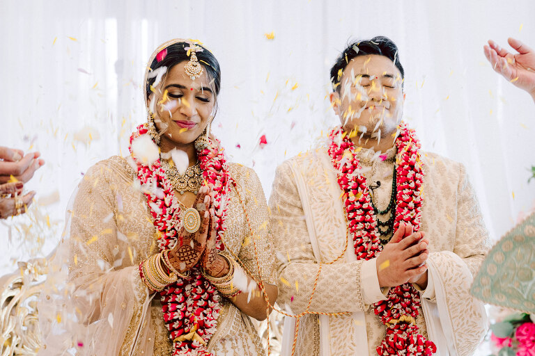I first crossed paths with Xavier a few years back at Danny and Andy's wedding, where he stood as one of the groomsmen at The Ryland Inn in 2021. When Xavier and Priya's own wedding day approached, I was deeply honored that he remembered me and reached out to discuss capturing their special day.
Meeting Priya and Xavier together during their engagement session in Princeton, NJ was an essential part of my process. It allowed me to delve into their personalities and witness the beautiful chemistry they shared. Engagements sessions, for me, serve as a cornerstone in establishing a genuine connection with my couples before the main event.

Priya and Xavier both started the wedding day at the Hyatt Regency in Jersey City, a venue boasting panoramic views of the Hudson River and the iconic Manhattan skyline. Against this breathtaking backdrop, they readied themselves, shared a heartwarming first look along the Hudson River Waterfront Walkway, then shortly after Priya and Xavier's family and friends joined them for photos.
As Priya watched from a balcony, Xavier's Baraat procession unfolded below, a lively affair marked by music, drums, and joyous celebrations. Following the Baraat wedding guests ascended to the wedding ceremony room at the Hyatt Regency, where a beautifully adorned Mandap awaited their union.

The cocktail hour tantalized guests with an array of delicious Indian cuisine, setting the stage for the grand entrance into the candlelit reception hall. Priya and Xavier stepped in, resplendent in their evening attire, launching into their first dance. This was followed by the traditional Filipino money dance,

Throughout the evening, dance performances, heartfelt parent dances, and touching speeches filled the air with love and laughter. Priya and Xavier's faces radiated with pure joy, reflecting the love that enveloped them on their special day.

Priya and Xavier Hyatt Regency Jersey City NJ wedding documented by by Karis | Hey Karis | Destination Wedding Photographer | Manhattan, Catskills, Hudson Valley, Brooklyn and NJ | Destination Elopement, Destination Wedding Photographer | Hey Karis is fun documentary wedding and elopement photographer based in NY, NJ.
