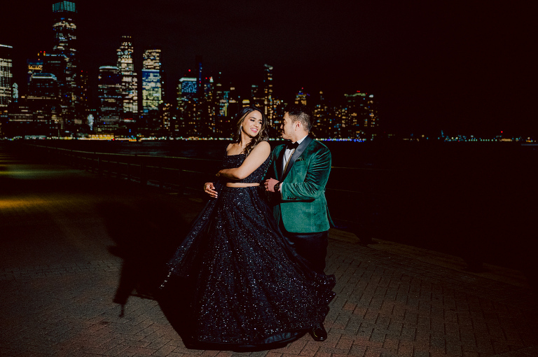 I first crossed paths with Xavier a few years back at Danny and Andy's wedding, where he stood as one of the groomsmen at The Ryland Inn in 2021. When Xavier and Priya's own wedding day approached, I was deeply honored that he remembered me and reached out to discuss capturing their special day. Meeting Priya and Xavier together during their engagement session in Princeton, NJ was an essential part of my process. It allowed me to delve into their personalities and witness the beautiful chemistry they shared. Engagements sessions, for me, serve as a cornerstone in establishing a genuine connection with my couples before the main event. Priya and Xavier both started the wedding day at the Hyatt Regency in Jersey City, a venue boasting panoramic views of the Hudson River and the iconic Manhattan skyline. Against this breathtaking backdrop, they readied themselves, shared a heartwarming first look along the Hudson River Waterfront Walkway, then shortly after Priya and Xavier's family and friends joined them for photos. As Priya watched from a balcony, Xavier's Baraat procession unfolded below, a lively affair marked by music, drums, and joyous celebrations. Following the Baraat wedding guests ascended to the wedding ceremony room at the Hyatt Regency, where a beautifully adorned Mandap awaited their union. The cocktail hour tantalized guests with an array of delicious Indian cuisine, setting the stage for the grand entrance into the candlelit reception hall. Priya and Xavier stepped in, resplendent in their evening attire, launching into their first dance. This was followed by the traditional Filipino money dance, Throughout the evening, dance performances, heartfelt parent dances, and touching speeches filled the air with love and laughter. Priya and Xavier's faces radiated with pure joy, reflecting the love that enveloped them on their special day. Priya and Xavier Hyatt Regency Jersey City NJ wedding documented by by Karis | Hey Karis | Destination Wedding Photographer | Manhattan, Catskills, Hudson Valley, Brooklyn and NJ | Destination Elopement, Destination Wedding Photographer | Hey Karis is fun documentary wedding and elopement photographer based in NY, NJ.