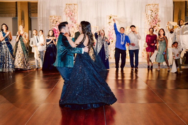 I first crossed paths with Xavier a few years back at Danny and Andy's wedding, where he stood as one of the groomsmen at The Ryland Inn in 2021. When Xavier and Priya's own wedding day approached, I was deeply honored that he remembered me and reached out to discuss capturing their special day. Meeting Priya and Xavier together during their engagement session in Princeton, NJ was an essential part of my process. It allowed me to delve into their personalities and witness the beautiful chemistry they shared. Engagements sessions, for me, serve as a cornerstone in establishing a genuine connection with my couples before the main event. Priya and Xavier both started the wedding day at the Hyatt Regency in Jersey City, a venue boasting panoramic views of the Hudson River and the iconic Manhattan skyline. Against this breathtaking backdrop, they readied themselves, shared a heartwarming first look along the Hudson River Waterfront Walkway, then shortly after Priya and Xavier's family and friends joined them for photos. As Priya watched from a balcony, Xavier's Baraat procession unfolded below, a lively affair marked by music, drums, and joyous celebrations. Following the Baraat wedding guests ascended to the wedding ceremony room at the Hyatt Regency, where a beautifully adorned Mandap awaited their union. The cocktail hour tantalized guests with an array of delicious Indian cuisine, setting the stage for the grand entrance into the candlelit reception hall. Priya and Xavier stepped in, resplendent in their evening attire, launching into their first dance. This was followed by the traditional Filipino money dance, Throughout the evening, dance performances, heartfelt parent dances, and touching speeches filled the air with love and laughter. Priya and Xavier's faces radiated with pure joy, reflecting the love that enveloped them on their special day. Priya and Xavier Hyatt Regency Jersey City NJ wedding documented by by Karis | Hey Karis | Destination Wedding Photographer | Manhattan, Catskills, Hudson Valley, Brooklyn and NJ | Destination Elopement, Destination Wedding Photographer | Hey Karis is fun documentary wedding and elopement photographer based in NY, NJ.