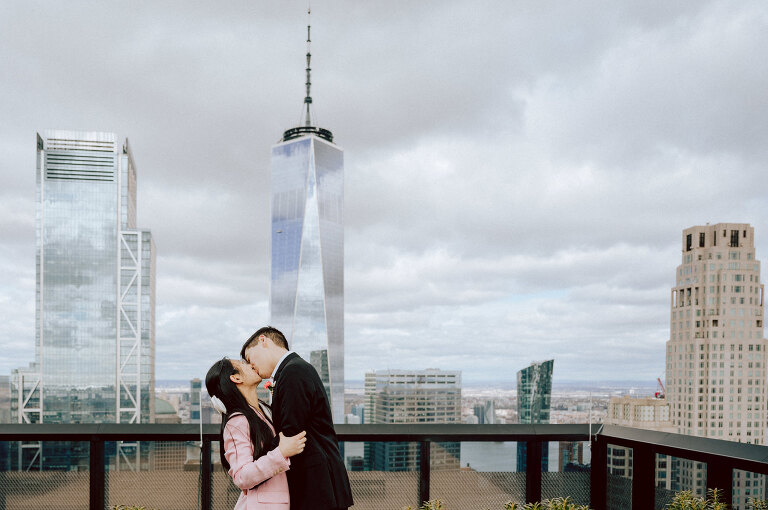 Alicia and Kevin made the bold decision to elope in the heart of the Big Apple before bidding adieu to city life and embracing suburban tranquility in New Jersey. Their choice resonates; after all, there's something undeniably magnetic about tying the knot in NYC that sets it apart from anywhere else in the world. Less than two weeks before their planned elopement at NYC City Hall, Alicia and Kevin reached out to me. I promptly scheduled a call to delve into the details, eager to understand their vision and expectations for their special day. It was essential for me to grasp their vibe and personalities; forging this connection and building relationship before the big day is super important to me. On April 5, I rendezvoused with Alicia and Kevin outside The Office of the City Clerk - Marriage Bureau. Despite hoping for a warm, sunny day, the brisk April air lingered, accompanied by a chilly breeze. Accompanied by a friend who served as their witness, we walked into the building. My camera was ready from outside documenting Alicia and Kevin, as I wanted to tell their story from beginning to end. Inside, we navigated the bureaucratic procedures, clicking away at Alicia and Kevin as they pleasantly waited for their number to be called. With paperwork signed and formalities concluded, Alicia and Kevin became husband and wife in the blink of an eye. We stayed a while longer inside the marriage bureau took the opportunity to capture some timeless moments posing on the iconic green sofa and NYC City Hall wall mural. Then we journeyed outside and wandered the vibrant bustling streets of NYC for some more photos. And what better way to conclude Alicia and Kevin's NYC City Hall elopement than with a quintessential New York slice. Alicia and Kevin NYC City Hall NY Elopement documented by by Karis | Hey Karis | Destination Wedding Photographer | Manhattan, Catskills, Hudson Valley, Brooklyn and NJ | Destination Elopement, Destination Wedding Photographer | Hey Karis is fun documentary wedding and elopement photographer based in NY, NJ.