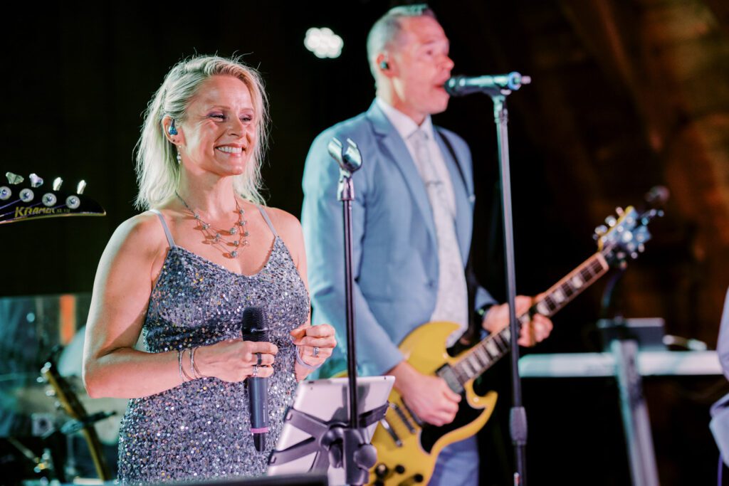 Malia and Aidan, currently residing in DC with their beloved pup Max, envisioned a wedding that reflected their laid-back, natural style. When we first chatted back in February 2023, they emphasized their desire for relaxed, fun, and candid photos that captured genuine moments.
Choosing The Barn at Perona Farms was a perfect fit for Malia and Aidan. Nestled amidst charming rustic surroundings and abundant nature, the venue complemented their preference for an authentic and unposed wedding day experience.
The ceremony took place outdoors on the lush lawn of The Barn at Perona Farms, exactly as they had envisioned – sweet, whimsy, and just the way they wanted it. Guests enjoyed a leisurely cocktail hour accompanied by live music courtesy of the talented Blue Label Band. The air was filled with the sounds of laughter and the clinking of wine glasses as everyone soaked in the joyful atmosphere.
As the evening progressed upstairs at The Barn, the ambiance was transformed by Moonlit Acres' stunning floral arrangements, candles, and elegant drapes. The space slowly filled with guests, reconnecting and sharing stories, delighted to be together again.
Then, the moment everyone had been waiting for: Malia and Aidan entered the room, surrounded by loved ones, and shared their first dance together.
Malia and Aidan's The Barn at Perona Farms NJ wedding documented by by Karis | Hey Karis | Destination Wedding Photographer | Manhattan, Catskills, Hudson Valley, Brooklyn and NJ | Destination Elopement, Destination Wedding Photographer | Hey Karis is fun documentary wedding and elopement photographer based in NY, NJ.