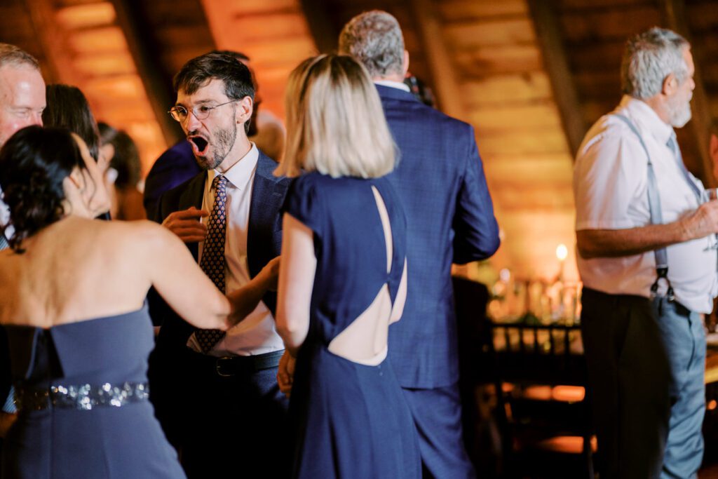 Malia and Aidan, currently residing in DC with their beloved pup Max, envisioned a wedding that reflected their laid-back, natural style. When we first chatted back in February 2023, they emphasized their desire for relaxed, fun, and candid photos that captured genuine moments.
Choosing The Barn at Perona Farms was a perfect fit for Malia and Aidan. Nestled amidst charming rustic surroundings and abundant nature, the venue complemented their preference for an authentic and unposed wedding day experience.
The ceremony took place outdoors on the lush lawn of The Barn at Perona Farms, exactly as they had envisioned – sweet, whimsy, and just the way they wanted it. Guests enjoyed a leisurely cocktail hour accompanied by live music courtesy of the talented Blue Label Band. The air was filled with the sounds of laughter and the clinking of wine glasses as everyone soaked in the joyful atmosphere.
As the evening progressed upstairs at The Barn, the ambiance was transformed by Moonlit Acres' stunning floral arrangements, candles, and elegant drapes. The space slowly filled with guests, reconnecting and sharing stories, delighted to be together again.
Then, the moment everyone had been waiting for: Malia and Aidan entered the room, surrounded by loved ones, and shared their first dance together.
Malia and Aidan's The Barn at Perona Farms NJ wedding documented by by Karis | Hey Karis | Destination Wedding Photographer | Manhattan, Catskills, Hudson Valley, Brooklyn and NJ | Destination Elopement, Destination Wedding Photographer | Hey Karis is fun documentary wedding and elopement photographer based in NY, NJ.