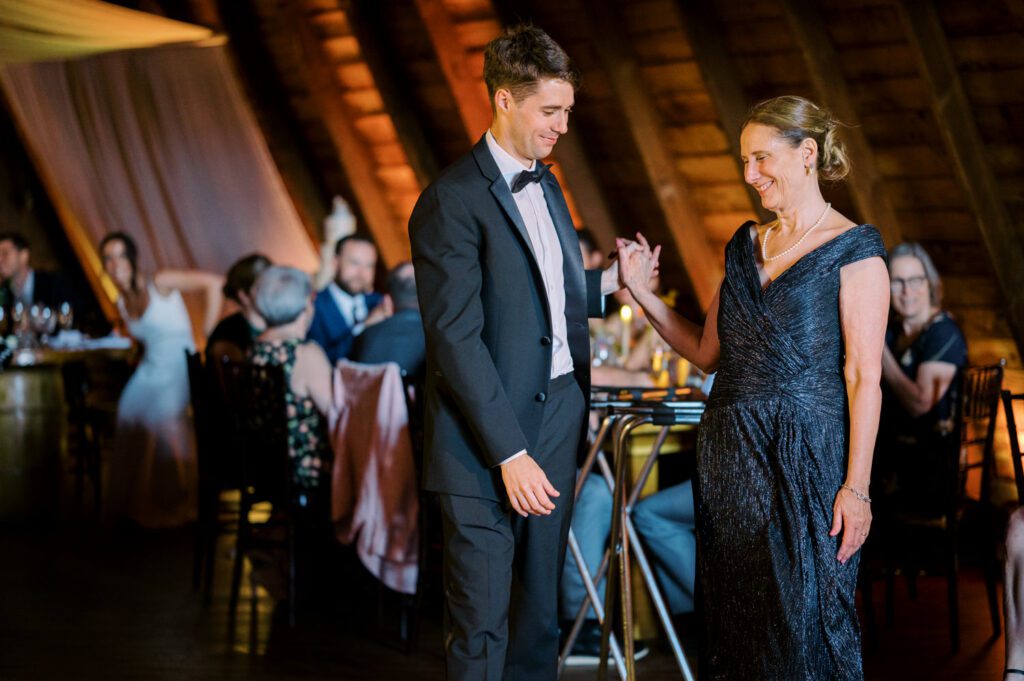 Malia and Aidan, currently residing in DC with their beloved pup Max, envisioned a wedding that reflected their laid-back, natural style. When we first chatted back in February 2023, they emphasized their desire for relaxed, fun, and candid photos that captured genuine moments.
Choosing The Barn at Perona Farms was a perfect fit for Malia and Aidan. Nestled amidst charming rustic surroundings and abundant nature, the venue complemented their preference for an authentic and unposed wedding day experience.
The ceremony took place outdoors on the lush lawn of The Barn at Perona Farms, exactly as they had envisioned – sweet, whimsy, and just the way they wanted it. Guests enjoyed a leisurely cocktail hour accompanied by live music courtesy of the talented Blue Label Band. The air was filled with the sounds of laughter and the clinking of wine glasses as everyone soaked in the joyful atmosphere.
As the evening progressed upstairs at The Barn, the ambiance was transformed by Moonlit Acres' stunning floral arrangements, candles, and elegant drapes. The space slowly filled with guests, reconnecting and sharing stories, delighted to be together again.
Then, the moment everyone had been waiting for: Malia and Aidan entered the room, surrounded by loved ones, and shared their first dance together.
Malia and Aidan's The Barn at Perona Farms NJ wedding documented by by Karis | Hey Karis | Destination Wedding Photographer | Manhattan, Catskills, Hudson Valley, Brooklyn and NJ | Destination Elopement, Destination Wedding Photographer | Hey Karis is fun documentary wedding and elopement photographer based in NY, NJ.