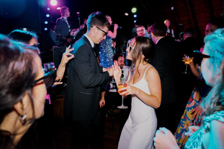 Malia and Aidan, currently residing in DC with their beloved pup Max, envisioned a wedding that reflected their laid-back, natural style. When we first chatted back in February 2023, they emphasized their desire for relaxed, fun, and candid photos that captured genuine moments.
Choosing The Barn at Perona Farms was a perfect fit for Malia and Aidan. Nestled amidst charming rustic surroundings and abundant nature, the venue complemented their preference for an authentic and unposed wedding day experience.
The ceremony took place outdoors on the lush lawn of The Barn at Perona Farms, exactly as they had envisioned – sweet, whimsy, and just the way they wanted it. Guests enjoyed a leisurely cocktail hour accompanied by live music courtesy of the talented Blue Label Band. The air was filled with the sounds of laughter and the clinking of wine glasses as everyone soaked in the joyful atmosphere.
As the evening progressed upstairs at The Barn, the ambiance was transformed by Moonlit Acres' stunning floral arrangements, candles, and elegant drapes. The space slowly filled with guests, reconnecting and sharing stories, delighted to be together again.
Then, the moment everyone had been waiting for: Malia and Aidan entered the room, surrounded by loved ones, and shared their first dance together.
Malia and Aidan's The Barn at Perona Farms NJ wedding documented by by Karis | Hey Karis | Destination Wedding Photographer | Manhattan, Catskills, Hudson Valley, Brooklyn and NJ | Destination Elopement, Destination Wedding Photographer | Hey Karis is fun documentary wedding and elopement photographer based in NY, NJ.