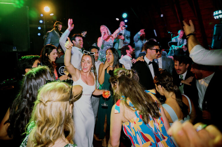 Malia and Aidan, currently residing in DC with their beloved pup Max, envisioned a wedding that reflected their laid-back, natural style. When we first chatted back in February 2023, they emphasized their desire for relaxed, fun, and candid photos that captured genuine moments. Choosing The Barn at Perona Farms was a perfect fit for Malia and Aidan. Nestled amidst charming rustic surroundings and abundant nature, the venue complemented their preference for an authentic and unposed wedding day experience. The ceremony took place outdoors on the lush lawn of The Barn at Perona Farms, exactly as they had envisioned – sweet, whimsy, and just the way they wanted it. Guests enjoyed a leisurely cocktail hour accompanied by live music courtesy of the talented Blue Label Band. The air was filled with the sounds of laughter and the clinking of wine glasses as everyone soaked in the joyful atmosphere. As the evening progressed upstairs at The Barn, the ambiance was transformed by Moonlit Acres' stunning floral arrangements, candles, and elegant drapes. The space slowly filled with guests, reconnecting and sharing stories, delighted to be together again. Then, the moment everyone had been waiting for: Malia and Aidan entered the room, surrounded by loved ones, and shared their first dance together. Malia and Aidan's The Barn at Perona Farms NJ wedding documented by by Karis | Hey Karis | Destination Wedding Photographer | Manhattan, Catskills, Hudson Valley, Brooklyn and NJ | Destination Elopement, Destination Wedding Photographer | Hey Karis is fun documentary wedding and elopement photographer based in NY, NJ.