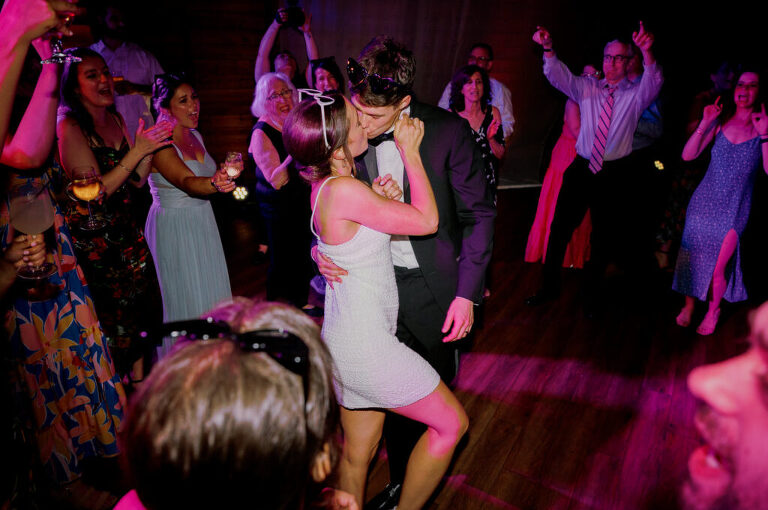 Malia and Aidan, currently residing in DC with their beloved pup Max, envisioned a wedding that reflected their laid-back, natural style. When we first chatted back in February 2023, they emphasized their desire for relaxed, fun, and candid photos that captured genuine moments. Choosing The Barn at Perona Farms was a perfect fit for Malia and Aidan. Nestled amidst charming rustic surroundings and abundant nature, the venue complemented their preference for an authentic and unposed wedding day experience. The ceremony took place outdoors on the lush lawn of The Barn at Perona Farms, exactly as they had envisioned – sweet, whimsy, and just the way they wanted it. Guests enjoyed a leisurely cocktail hour accompanied by live music courtesy of the talented Blue Label Band. The air was filled with the sounds of laughter and the clinking of wine glasses as everyone soaked in the joyful atmosphere. As the evening progressed upstairs at The Barn, the ambiance was transformed by Moonlit Acres' stunning floral arrangements, candles, and elegant drapes. The space slowly filled with guests, reconnecting and sharing stories, delighted to be together again. Then, the moment everyone had been waiting for: Malia and Aidan entered the room, surrounded by loved ones, and shared their first dance together. Malia and Aidan's The Barn at Perona Farms NJ wedding documented by by Karis | Hey Karis | Destination Wedding Photographer | Manhattan, Catskills, Hudson Valley, Brooklyn and NJ | Destination Elopement, Destination Wedding Photographer | Hey Karis is fun documentary wedding and elopement photographer based in NY, NJ.