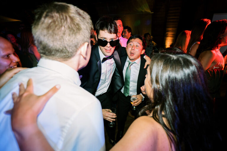 Malia and Aidan, currently residing in DC with their beloved pup Max, envisioned a wedding that reflected their laid-back, natural style. When we first chatted back in February 2023, they emphasized their desire for relaxed, fun, and candid photos that captured genuine moments. Choosing The Barn at Perona Farms was a perfect fit for Malia and Aidan. Nestled amidst charming rustic surroundings and abundant nature, the venue complemented their preference for an authentic and unposed wedding day experience. The ceremony took place outdoors on the lush lawn of The Barn at Perona Farms, exactly as they had envisioned – sweet, whimsy, and just the way they wanted it. Guests enjoyed a leisurely cocktail hour accompanied by live music courtesy of the talented Blue Label Band. The air was filled with the sounds of laughter and the clinking of wine glasses as everyone soaked in the joyful atmosphere. As the evening progressed upstairs at The Barn, the ambiance was transformed by Moonlit Acres' stunning floral arrangements, candles, and elegant drapes. The space slowly filled with guests, reconnecting and sharing stories, delighted to be together again. Then, the moment everyone had been waiting for: Malia and Aidan entered the room, surrounded by loved ones, and shared their first dance together. Malia and Aidan's The Barn at Perona Farms NJ wedding documented by by Karis | Hey Karis | Destination Wedding Photographer | Manhattan, Catskills, Hudson Valley, Brooklyn and NJ | Destination Elopement, Destination Wedding Photographer | Hey Karis is fun documentary wedding and elopement photographer based in NY, NJ.