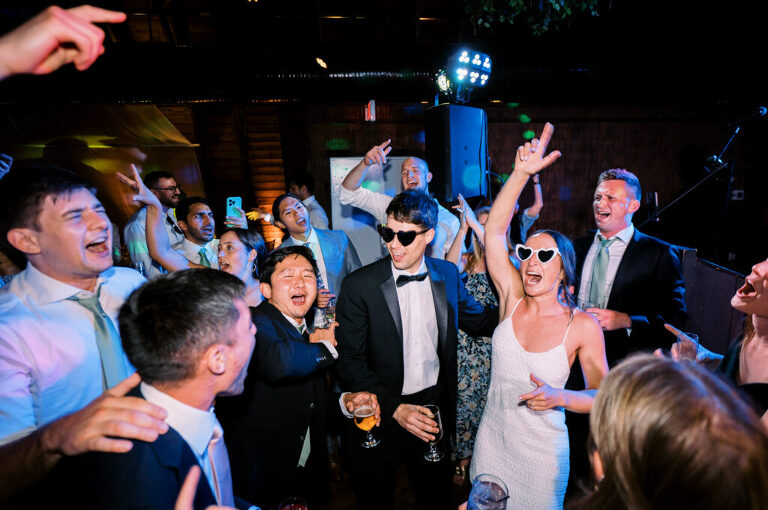 Malia and Aidan, currently residing in DC with their beloved pup Max, envisioned a wedding that reflected their laid-back, natural style. When we first chatted back in February 2023, they emphasized their desire for relaxed, fun, and candid photos that captured genuine moments. Choosing The Barn at Perona Farms was a perfect fit for Malia and Aidan. Nestled amidst charming rustic surroundings and abundant nature, the venue complemented their preference for an authentic and unposed wedding day experience. The ceremony took place outdoors on the lush lawn of The Barn at Perona Farms, exactly as they had envisioned – sweet, whimsy, and just the way they wanted it. Guests enjoyed a leisurely cocktail hour accompanied by live music courtesy of the talented Blue Label Band. The air was filled with the sounds of laughter and the clinking of wine glasses as everyone soaked in the joyful atmosphere. As the evening progressed upstairs at The Barn, the ambiance was transformed by Moonlit Acres' stunning floral arrangements, candles, and elegant drapes. The space slowly filled with guests, reconnecting and sharing stories, delighted to be together again. Then, the moment everyone had been waiting for: Malia and Aidan entered the room, surrounded by loved ones, and shared their first dance together. Malia and Aidan's The Barn at Perona Farms NJ wedding documented by by Karis | Hey Karis | Destination Wedding Photographer | Manhattan, Catskills, Hudson Valley, Brooklyn and NJ | Destination Elopement, Destination Wedding Photographer | Hey Karis is fun documentary wedding and elopement photographer based in NY, NJ.