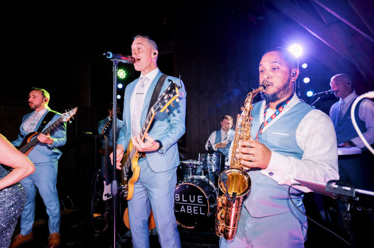 Malia and Aidan, currently residing in DC with their beloved pup Max, envisioned a wedding that reflected their laid-back, natural style. When we first chatted back in February 2023, they emphasized their desire for relaxed, fun, and candid photos that captured genuine moments. Choosing The Barn at Perona Farms was a perfect fit for Malia and Aidan. Nestled amidst charming rustic surroundings and abundant nature, the venue complemented their preference for an authentic and unposed wedding day experience. The ceremony took place outdoors on the lush lawn of The Barn at Perona Farms, exactly as they had envisioned – sweet, whimsy, and just the way they wanted it. Guests enjoyed a leisurely cocktail hour accompanied by live music courtesy of the talented Blue Label Band. The air was filled with the sounds of laughter and the clinking of wine glasses as everyone soaked in the joyful atmosphere. As the evening progressed upstairs at The Barn, the ambiance was transformed by Moonlit Acres' stunning floral arrangements, candles, and elegant drapes. The space slowly filled with guests, reconnecting and sharing stories, delighted to be together again. Then, the moment everyone had been waiting for: Malia and Aidan entered the room, surrounded by loved ones, and shared their first dance together. Malia and Aidan's The Barn at Perona Farms NJ wedding documented by by Karis | Hey Karis | Destination Wedding Photographer | Manhattan, Catskills, Hudson Valley, Brooklyn and NJ | Destination Elopement, Destination Wedding Photographer | Hey Karis is fun documentary wedding and elopement photographer based in NY, NJ.