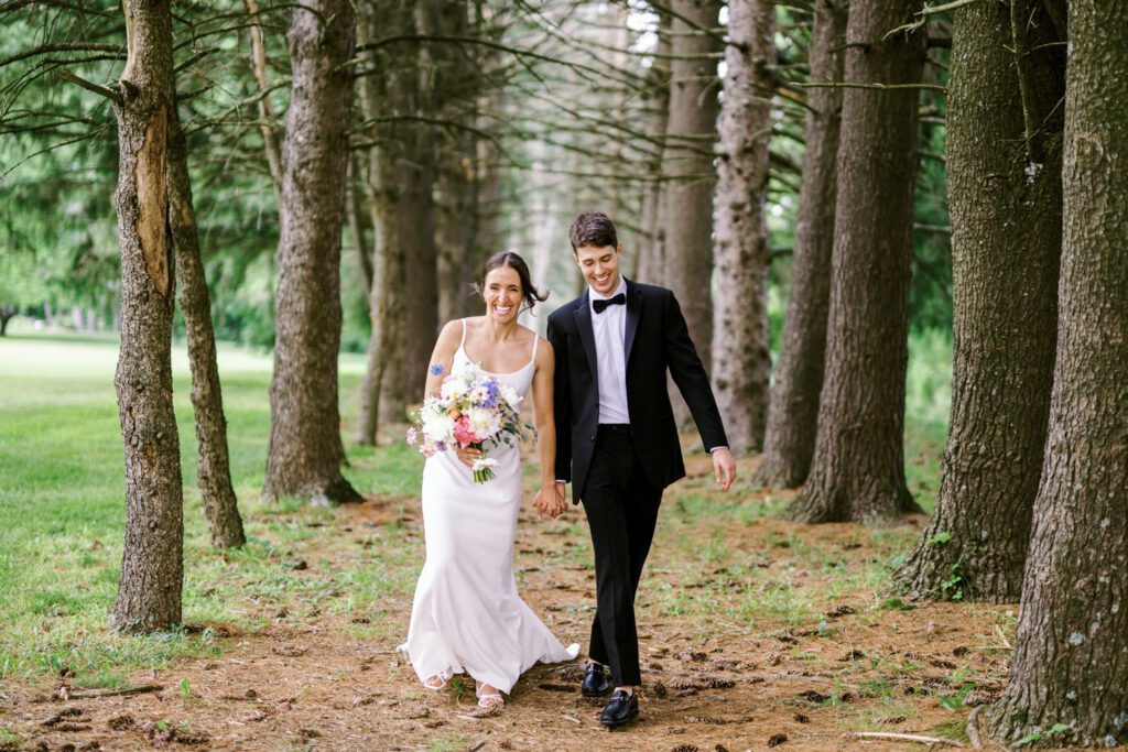 Malia and Aidan, currently residing in DC with their beloved pup Max, envisioned a wedding that reflected their laid-back, natural style. When we first chatted back in February 2023, they emphasized their desire for relaxed, fun, and candid photos that captured genuine moments.
Choosing The Barn at Perona Farms was a perfect fit for Malia and Aidan. Nestled amidst charming rustic surroundings and abundant nature, the venue complemented their preference for an authentic and unposed wedding day experience.
The ceremony took place outdoors on the lush lawn of The Barn at Perona Farms, exactly as they had envisioned – sweet, whimsy, and just the way they wanted it. Guests enjoyed a leisurely cocktail hour accompanied by live music courtesy of the talented Blue Label Band. The air was filled with the sounds of laughter and the clinking of wine glasses as everyone soaked in the joyful atmosphere.
As the evening progressed upstairs at The Barn, the ambiance was transformed by Moonlit Acres' stunning floral arrangements, candles, and elegant drapes. The space slowly filled with guests, reconnecting and sharing stories, delighted to be together again.
Then, the moment everyone had been waiting for: Malia and Aidan entered the room, surrounded by loved ones, and shared their first dance together.
Malia and Aidan's The Barn at Perona Farms NJ wedding documented by by Karis | Hey Karis | Destination Wedding Photographer | Manhattan, Catskills, Hudson Valley, Brooklyn and NJ | Destination Elopement, Destination Wedding Photographer | Hey Karis is fun documentary wedding and elopement photographer based in NY, NJ.