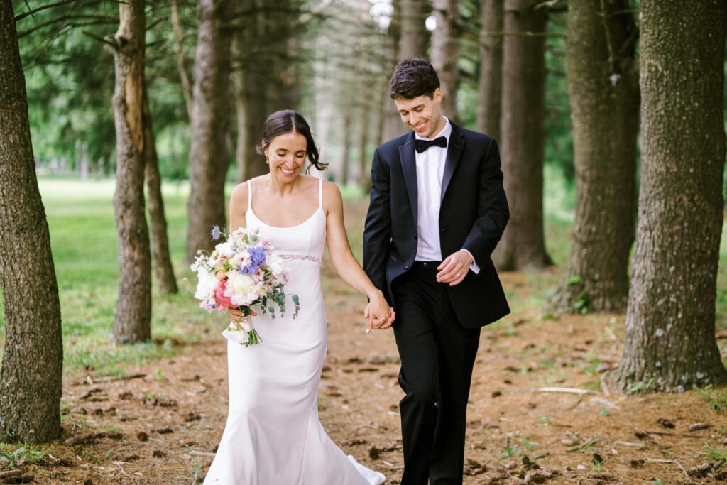 Malia and Aidan, currently residing in DC with their beloved pup Max, envisioned a wedding that reflected their laid-back, natural style. When we first chatted back in February 2023, they emphasized their desire for relaxed, fun, and candid photos that captured genuine moments.
Choosing The Barn at Perona Farms was a perfect fit for Malia and Aidan. Nestled amidst charming rustic surroundings and abundant nature, the venue complemented their preference for an authentic and unposed wedding day experience.
The ceremony took place outdoors on the lush lawn of The Barn at Perona Farms, exactly as they had envisioned – sweet, whimsy, and just the way they wanted it. Guests enjoyed a leisurely cocktail hour accompanied by live music courtesy of the talented Blue Label Band. The air was filled with the sounds of laughter and the clinking of wine glasses as everyone soaked in the joyful atmosphere.
As the evening progressed upstairs at The Barn, the ambiance was transformed by Moonlit Acres' stunning floral arrangements, candles, and elegant drapes. The space slowly filled with guests, reconnecting and sharing stories, delighted to be together again.
Then, the moment everyone had been waiting for: Malia and Aidan entered the room, surrounded by loved ones, and shared their first dance together.
Malia and Aidan's The Barn at Perona Farms NJ wedding documented by by Karis | Hey Karis | Destination Wedding Photographer | Manhattan, Catskills, Hudson Valley, Brooklyn and NJ | Destination Elopement, Destination Wedding Photographer | Hey Karis is fun documentary wedding and elopement photographer based in NY, NJ.