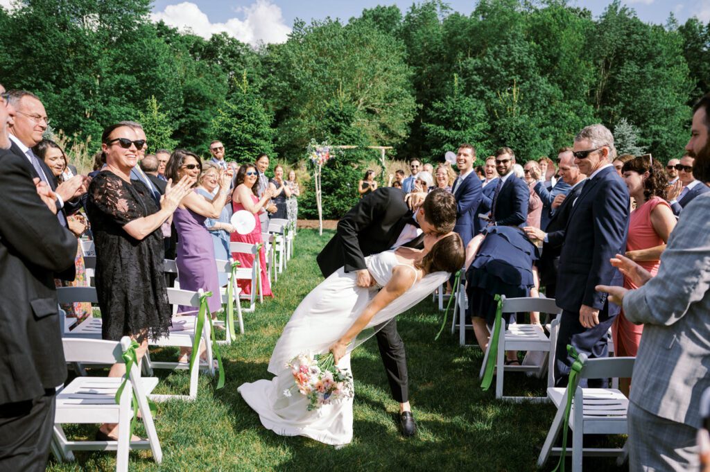 Malia and Aidan, currently residing in DC with their beloved pup Max, envisioned a wedding that reflected their laid-back, natural style. When we first chatted back in February 2023, they emphasized their desire for relaxed, fun, and candid photos that captured genuine moments.
Choosing The Barn at Perona Farms was a perfect fit for Malia and Aidan. Nestled amidst charming rustic surroundings and abundant nature, the venue complemented their preference for an authentic and unposed wedding day experience.
The ceremony took place outdoors on the lush lawn of The Barn at Perona Farms, exactly as they had envisioned – sweet, whimsy, and just the way they wanted it. Guests enjoyed a leisurely cocktail hour accompanied by live music courtesy of the talented Blue Label Band. The air was filled with the sounds of laughter and the clinking of wine glasses as everyone soaked in the joyful atmosphere.
As the evening progressed upstairs at The Barn, the ambiance was transformed by Moonlit Acres' stunning floral arrangements, candles, and elegant drapes. The space slowly filled with guests, reconnecting and sharing stories, delighted to be together again.
Then, the moment everyone had been waiting for: Malia and Aidan entered the room, surrounded by loved ones, and shared their first dance together.
Malia and Aidan's The Barn at Perona Farms NJ wedding documented by by Karis | Hey Karis | Destination Wedding Photographer | Manhattan, Catskills, Hudson Valley, Brooklyn and NJ | Destination Elopement, Destination Wedding Photographer | Hey Karis is fun documentary wedding and elopement photographer based in NY, NJ.