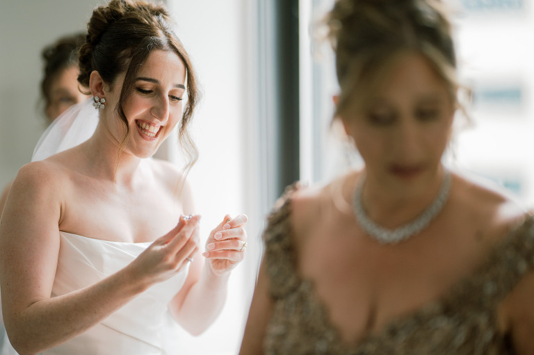 I first connected with Rachel through a DM on Instagram. From that initial message, our conversations quickly evolved, and soon I was part of her wedding journey. Rachel's bright, bubbly personality shone through as she excitedly shared stories about her and Zach, including his proposal. When I met them for their engagement session in the Meatpacking District of New York City, it was clear they were made for each other. The way Zach’s eyes lit up when he looked at Rachel, and how their contrasting personalities complemented one another, was undeniable. It felt like hearts were falling from the sky that day.
Their wedding at Liberty House in Jersey City on June 30, 2024, was just as magical. All the love and emotions were on full display, and the excitement was palpable in the air. Both Rachel and Zach’s families were overjoyed to witness their children marry the loves of their lives. You could see it on their faces – pure happiness.
In keeping with Jewish tradition, Rachel and Zach held a beautiful Badeken and Ketubah signing, surrounded by their closest family and friends. Despite the rain, the ceremony was moved indoors at Liberty House, and thanks to the venue’s impressive panoramic windows, it still felt as if we were outside, with the stunning city skyline as our backdrop.
Rachel and Zach made their grand entrance into the reception with incredible energy, setting the tone for an evening filled with love, laughter, and celebration. The rest of the night was pure joy as their family and friends danced the night away, making unforgettable memories at Liberty House.
 Rachel and Zach Liberty House Jersey City NJ wedding documented by by Karis | Hey Karis | Destination Wedding Photographer | Manhattan, Catskills, Hudson Valley, Brooklyn and NJ | Destination Elopement, Destination Wedding Photographer | Hey Karis is fun documentary wedding and elopement photographer based in NY, NJ.