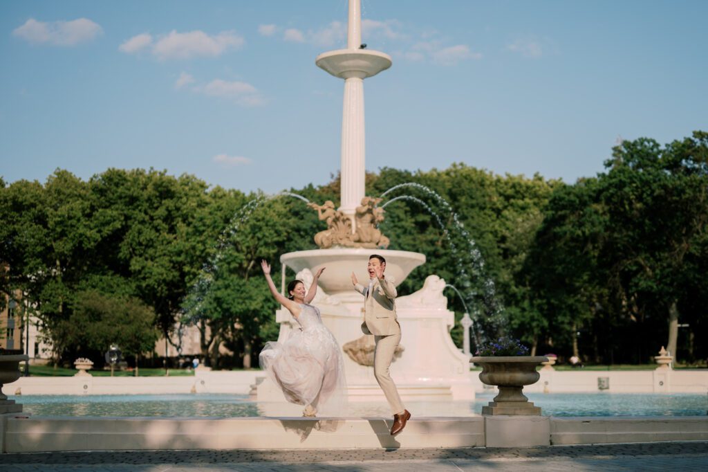 Leah and Kevin’s wedding was nothing short of enchanting—fitting for two fellow Harry Potter fans! From the emotional first look to their joyous celebration surrounded by family and friends, their special day was filled with love, laughter, and memorable moments.
Their day began early at The View at Lincoln Park, one of Jersey City’s newest and most unique wedding venues, part of the esteemed Landmark Venues collection. Nestled within the historic Lincoln Park, The View offers a modern yet timeless space with breathtaking scenery. The venue’s design is a stunning adaptive reuse of the original Lincoln Lodge (est. 1929), featuring preserved stone facades, timber beams, and antique fixtures. This blend of contemporary elegance and historic charm makes it a truly one-of-a-kind setting for weddings.
When I arrived, I was excited to explore the property and its surroundings. The View’s lush grounds, picturesque willow tree, and nearby landmarks, including the Lincoln Park Fountain, provide endless opportunities for stunning photographs. The morning was quiet as Leah and her bridesmaids arrived, carrying their dresses over their shoulders, and settled into the spacious bridal suite. Later, Kevin and their families arrived, and the anticipation began to build.
Leah and Kevin’s first look by the willow tree was a moment to remember. As the wind danced through the branches, tears filled Leah’s eyes as they read their vows to each other—an intimate, heartfelt exchange that perfectly set the tone for the day.
Guests began filling the chairs in Lincoln Room (the third-floor ceremony space), a modern area with large windows that allow natural light to flood in. This versatile room offers an elegant setting for ceremonies, with views of the surrounding park and cityscape. As Leah walked down the aisle with her father, they exchanged emotional glances, and the energy in the room was palpable.
The celebration moved to The Ballroom, The View’s stunning reception space. With its high ceilings, contemporary design, and floor-to-ceiling windows offering views of the park, the room was transformed into the perfect party atmosphere. Guests cheered as Leah and Kevin made their grand entrance, and their first dance kicked off an evening of fun, laughter, and memories.
Before the day concluded, Kevin had a special request for a photo by the Lincoln Park Fountain, a highlight of the park’s charm. We strolled over with Leah and Kevin to capture some magical portraits by the water. One of the great things about daytime weddings at The View is the ample natural light, ensuring we had beautiful lighting for photos even after the reception.
Leah and Kevin’s wedding was a joy to photograph, and The View at Lincoln Park provided the perfect backdrop for their unforgettable day. Congratulations to the happy couple—I’m so grateful to have been part of your story!
Leah and Kevin's The View at Lincoln Park Jersey City NJ documented by Karis from Hey Karis New York, Brooklyn, Hudson Valley NY and Catskills NY and NJ Wedding and NYC Elopement Photographer.
