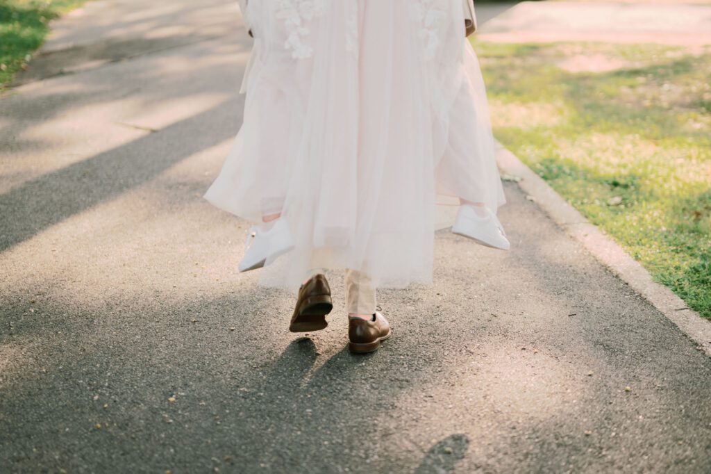 Leah and Kevin’s wedding was nothing short of enchanting—fitting for two fellow Harry Potter fans! From the emotional first look to their joyous celebration surrounded by family and friends, their special day was filled with love, laughter, and memorable moments.
Their day began early at The View at Lincoln Park, one of Jersey City’s newest and most unique wedding venues, part of the esteemed Landmark Venues collection. Nestled within the historic Lincoln Park, The View offers a modern yet timeless space with breathtaking scenery. The venue’s design is a stunning adaptive reuse of the original Lincoln Lodge (est. 1929), featuring preserved stone facades, timber beams, and antique fixtures. This blend of contemporary elegance and historic charm makes it a truly one-of-a-kind setting for weddings.
When I arrived, I was excited to explore the property and its surroundings. The View’s lush grounds, picturesque willow tree, and nearby landmarks, including the Lincoln Park Fountain, provide endless opportunities for stunning photographs. The morning was quiet as Leah and her bridesmaids arrived, carrying their dresses over their shoulders, and settled into the spacious bridal suite. Later, Kevin and their families arrived, and the anticipation began to build.
Leah and Kevin’s first look by the willow tree was a moment to remember. As the wind danced through the branches, tears filled Leah’s eyes as they read their vows to each other—an intimate, heartfelt exchange that perfectly set the tone for the day.
Guests began filling the chairs in Lincoln Room (the third-floor ceremony space), a modern area with large windows that allow natural light to flood in. This versatile room offers an elegant setting for ceremonies, with views of the surrounding park and cityscape. As Leah walked down the aisle with her father, they exchanged emotional glances, and the energy in the room was palpable.
The celebration moved to The Ballroom, The View’s stunning reception space. With its high ceilings, contemporary design, and floor-to-ceiling windows offering views of the park, the room was transformed into the perfect party atmosphere. Guests cheered as Leah and Kevin made their grand entrance, and their first dance kicked off an evening of fun, laughter, and memories.
Before the day concluded, Kevin had a special request for a photo by the Lincoln Park Fountain, a highlight of the park’s charm. We strolled over with Leah and Kevin to capture some magical portraits by the water. One of the great things about daytime weddings at The View is the ample natural light, ensuring we had beautiful lighting for photos even after the reception.
Leah and Kevin’s wedding was a joy to photograph, and The View at Lincoln Park provided the perfect backdrop for their unforgettable day. Congratulations to the happy couple—I’m so grateful to have been part of your story!
Leah and Kevin's The View at Lincoln Park Jersey City NJ documented by Karis from Hey Karis New York, Brooklyn, Hudson Valley NY and Catskills NY and NJ Wedding and NYC Elopement Photographer.
