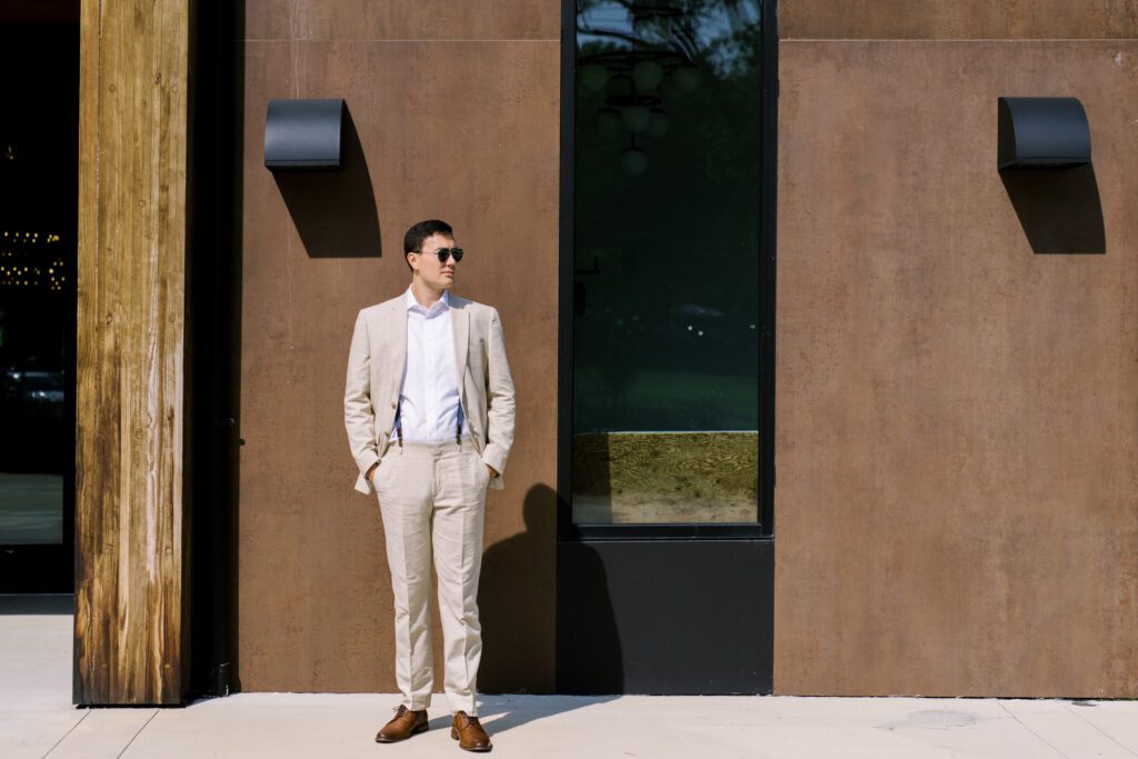 Leah and Kevin’s wedding was nothing short of enchanting—fitting for two fellow Harry Potter fans! From the emotional first look to their joyous celebration surrounded by family and friends, their special day was filled with love, laughter, and memorable moments.
Their day began early at The View at Lincoln Park, one of Jersey City’s newest and most unique wedding venues, part of the esteemed Landmark Venues collection. Nestled within the historic Lincoln Park, The View offers a modern yet timeless space with breathtaking scenery. The venue’s design is a stunning adaptive reuse of the original Lincoln Lodge (est. 1929), featuring preserved stone facades, timber beams, and antique fixtures. This blend of contemporary elegance and historic charm makes it a truly one-of-a-kind setting for weddings.
When I arrived, I was excited to explore the property and its surroundings. The View’s lush grounds, picturesque willow tree, and nearby landmarks, including the Lincoln Park Fountain, provide endless opportunities for stunning photographs. The morning was quiet as Leah and her bridesmaids arrived, carrying their dresses over their shoulders, and settled into the spacious bridal suite. Later, Kevin and their families arrived, and the anticipation began to build.
Leah and Kevin’s first look by the willow tree was a moment to remember. As the wind danced through the branches, tears filled Leah’s eyes as they read their vows to each other—an intimate, heartfelt exchange that perfectly set the tone for the day.
Guests began filling the chairs in Lincoln Room (the third-floor ceremony space), a modern area with large windows that allow natural light to flood in. This versatile room offers an elegant setting for ceremonies, with views of the surrounding park and cityscape. As Leah walked down the aisle with her father, they exchanged emotional glances, and the energy in the room was palpable.
The celebration moved to The Ballroom, The View’s stunning reception space. With its high ceilings, contemporary design, and floor-to-ceiling windows offering views of the park, the room was transformed into the perfect party atmosphere. Guests cheered as Leah and Kevin made their grand entrance, and their first dance kicked off an evening of fun, laughter, and memories.
Before the day concluded, Kevin had a special request for a photo by the Lincoln Park Fountain, a highlight of the park’s charm. We strolled over with Leah and Kevin to capture some magical portraits by the water. One of the great things about daytime weddings at The View is the ample natural light, ensuring we had beautiful lighting for photos even after the reception.
Leah and Kevin’s wedding was a joy to photograph, and The View at Lincoln Park provided the perfect backdrop for their unforgettable day. Congratulations to the happy couple—I’m so grateful to have been part of your story!
Leah and Kevin's The View at Lincoln Park Jersey City NJ documented by Karis from Hey Karis New York, Brooklyn, Hudson Valley NY and Catskills NY and NJ Wedding and NYC Elopement Photographer.
