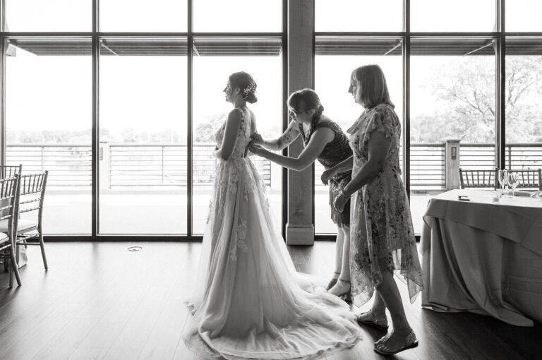 Leah and Kevin’s wedding was nothing short of enchanting—fitting for two fellow Harry Potter fans! From the emotional first look to their joyous celebration surrounded by family and friends, their special day was filled with love, laughter, and memorable moments.
Their day began early at The View at Lincoln Park, one of Jersey City’s newest and most unique wedding venues, part of the esteemed Landmark Venues collection. Nestled within the historic Lincoln Park, The View offers a modern yet timeless space with breathtaking scenery. The venue’s design is a stunning adaptive reuse of the original Lincoln Lodge (est. 1929), featuring preserved stone facades, timber beams, and antique fixtures. This blend of contemporary elegance and historic charm makes it a truly one-of-a-kind setting for weddings.
When I arrived, I was excited to explore the property and its surroundings. The View’s lush grounds, picturesque willow tree, and nearby landmarks, including the Lincoln Park Fountain, provide endless opportunities for stunning photographs. The morning was quiet as Leah and her bridesmaids arrived, carrying their dresses over their shoulders, and settled into the spacious bridal suite. Later, Kevin and their families arrived, and the anticipation began to build.
Leah and Kevin’s first look by the willow tree was a moment to remember. As the wind danced through the branches, tears filled Leah’s eyes as they read their vows to each other—an intimate, heartfelt exchange that perfectly set the tone for the day.
Guests began filling the chairs in Lincoln Room (the third-floor ceremony space), a modern area with large windows that allow natural light to flood in. This versatile room offers an elegant setting for ceremonies, with views of the surrounding park and cityscape. As Leah walked down the aisle with her father, they exchanged emotional glances, and the energy in the room was palpable.
The celebration moved to The Ballroom, The View’s stunning reception space. With its high ceilings, contemporary design, and floor-to-ceiling windows offering views of the park, the room was transformed into the perfect party atmosphere. Guests cheered as Leah and Kevin made their grand entrance, and their first dance kicked off an evening of fun, laughter, and memories.
Before the day concluded, Kevin had a special request for a photo by the Lincoln Park Fountain, a highlight of the park’s charm. We strolled over with Leah and Kevin to capture some magical portraits by the water. One of the great things about daytime weddings at The View is the ample natural light, ensuring we had beautiful lighting for photos even after the reception.
Leah and Kevin’s wedding was a joy to photograph, and The View at Lincoln Park provided the perfect backdrop for their unforgettable day. Congratulations to the happy couple—I’m so grateful to have been part of your story!
Leah and Kevin's The View at Lincoln Park Jersey City NJ documented by Karis from Hey Karis New York, Brooklyn, Hudson Valley NY and Catskills NY and NJ Wedding and NYC Elopement Photographer.
