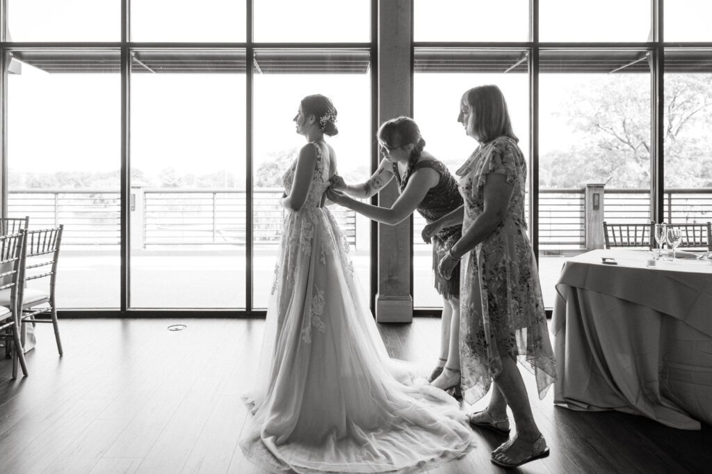 Leah and Kevin’s wedding was nothing short of enchanting—fitting for two fellow Harry Potter fans! From the emotional first look to their joyous celebration surrounded by family and friends, their special day was filled with love, laughter, and memorable moments.
Their day began early at The View at Lincoln Park, one of Jersey City’s newest and most unique wedding venues, part of the esteemed Landmark Venues collection. Nestled within the historic Lincoln Park, The View offers a modern yet timeless space with breathtaking scenery. The venue’s design is a stunning adaptive reuse of the original Lincoln Lodge (est. 1929), featuring preserved stone facades, timber beams, and antique fixtures. This blend of contemporary elegance and historic charm makes it a truly one-of-a-kind setting for weddings.
When I arrived, I was excited to explore the property and its surroundings. The View’s lush grounds, picturesque willow tree, and nearby landmarks, including the Lincoln Park Fountain, provide endless opportunities for stunning photographs. The morning was quiet as Leah and her bridesmaids arrived, carrying their dresses over their shoulders, and settled into the spacious bridal suite. Later, Kevin and their families arrived, and the anticipation began to build.
Leah and Kevin’s first look by the willow tree was a moment to remember. As the wind danced through the branches, tears filled Leah’s eyes as they read their vows to each other—an intimate, heartfelt exchange that perfectly set the tone for the day.
Guests began filling the chairs in Lincoln Room (the third-floor ceremony space), a modern area with large windows that allow natural light to flood in. This versatile room offers an elegant setting for ceremonies, with views of the surrounding park and cityscape. As Leah walked down the aisle with her father, they exchanged emotional glances, and the energy in the room was palpable.
The celebration moved to The Ballroom, The View’s stunning reception space. With its high ceilings, contemporary design, and floor-to-ceiling windows offering views of the park, the room was transformed into the perfect party atmosphere. Guests cheered as Leah and Kevin made their grand entrance, and their first dance kicked off an evening of fun, laughter, and memories.
Before the day concluded, Kevin had a special request for a photo by the Lincoln Park Fountain, a highlight of the park’s charm. We strolled over with Leah and Kevin to capture some magical portraits by the water. One of the great things about daytime weddings at The View is the ample natural light, ensuring we had beautiful lighting for photos even after the reception.
Leah and Kevin’s wedding was a joy to photograph, and The View at Lincoln Park provided the perfect backdrop for their unforgettable day. Congratulations to the happy couple—I’m so grateful to have been part of your story!
Leah and Kevin's The View at Lincoln Park Jersey City NJ documented by Karis from Hey Karis New York, Brooklyn, Hudson Valley NY and Catskills NY and NJ Wedding and NYC Elopement Photographer.
