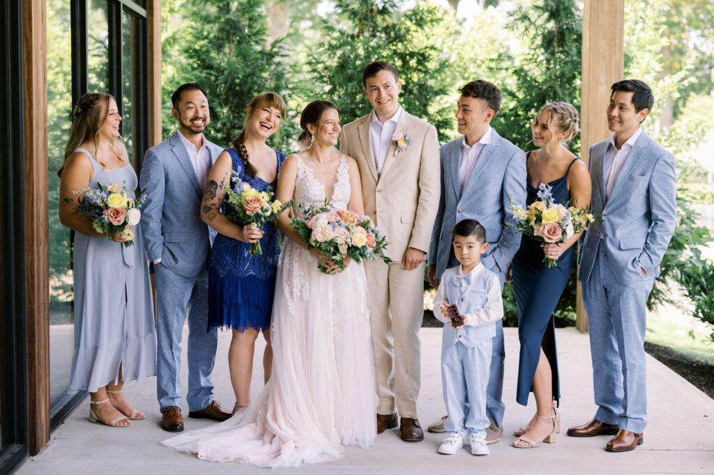 Leah and Kevin’s wedding was nothing short of enchanting—fitting for two fellow Harry Potter fans! From the emotional first look to their joyous celebration surrounded by family and friends, their special day was filled with love, laughter, and memorable moments.
Their day began early at The View at Lincoln Park, one of Jersey City’s newest and most unique wedding venues, part of the esteemed Landmark Venues collection. Nestled within the historic Lincoln Park, The View offers a modern yet timeless space with breathtaking scenery. The venue’s design is a stunning adaptive reuse of the original Lincoln Lodge (est. 1929), featuring preserved stone facades, timber beams, and antique fixtures. This blend of contemporary elegance and historic charm makes it a truly one-of-a-kind setting for weddings.
When I arrived, I was excited to explore the property and its surroundings. The View’s lush grounds, picturesque willow tree, and nearby landmarks, including the Lincoln Park Fountain, provide endless opportunities for stunning photographs. The morning was quiet as Leah and her bridesmaids arrived, carrying their dresses over their shoulders, and settled into the spacious bridal suite. Later, Kevin and their families arrived, and the anticipation began to build.
Leah and Kevin’s first look by the willow tree was a moment to remember. As the wind danced through the branches, tears filled Leah’s eyes as they read their vows to each other—an intimate, heartfelt exchange that perfectly set the tone for the day.
Guests began filling the chairs in Lincoln Room (the third-floor ceremony space), a modern area with large windows that allow natural light to flood in. This versatile room offers an elegant setting for ceremonies, with views of the surrounding park and cityscape. As Leah walked down the aisle with her father, they exchanged emotional glances, and the energy in the room was palpable.
The celebration moved to The Ballroom, The View’s stunning reception space. With its high ceilings, contemporary design, and floor-to-ceiling windows offering views of the park, the room was transformed into the perfect party atmosphere. Guests cheered as Leah and Kevin made their grand entrance, and their first dance kicked off an evening of fun, laughter, and memories.
Before the day concluded, Kevin had a special request for a photo by the Lincoln Park Fountain, a highlight of the park’s charm. We strolled over with Leah and Kevin to capture some magical portraits by the water. One of the great things about daytime weddings at The View is the ample natural light, ensuring we had beautiful lighting for photos even after the reception.
Leah and Kevin’s wedding was a joy to photograph, and The View at Lincoln Park provided the perfect backdrop for their unforgettable day. Congratulations to the happy couple—I’m so grateful to have been part of your story!
Leah and Kevin's The View at Lincoln Park Jersey City NJ documented by Karis from Hey Karis New York, Brooklyn, Hudson Valley NY and Catskills NY and NJ Wedding and NYC Elopement Photographer.
