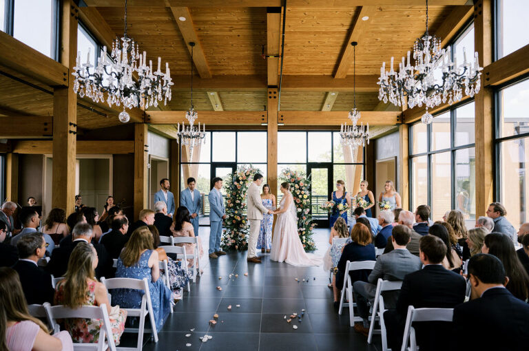 Leah and Kevin’s wedding was nothing short of enchanting—fitting for two fellow Harry Potter fans! From the emotional first look to their joyous celebration surrounded by family and friends, their special day was filled with love, laughter, and memorable moments.
Their day began early at The View at Lincoln Park, one of Jersey City’s newest and most unique wedding venues, part of the esteemed Landmark Venues collection. Nestled within the historic Lincoln Park, The View offers a modern yet timeless space with breathtaking scenery. The venue’s design is a stunning adaptive reuse of the original Lincoln Lodge (est. 1929), featuring preserved stone facades, timber beams, and antique fixtures. This blend of contemporary elegance and historic charm makes it a truly one-of-a-kind setting for weddings.
When I arrived, I was excited to explore the property and its surroundings. The View’s lush grounds, picturesque willow tree, and nearby landmarks, including the Lincoln Park Fountain, provide endless opportunities for stunning photographs. The morning was quiet as Leah and her bridesmaids arrived, carrying their dresses over their shoulders, and settled into the spacious bridal suite. Later, Kevin and their families arrived, and the anticipation began to build.
Leah and Kevin’s first look by the willow tree was a moment to remember. As the wind danced through the branches, tears filled Leah’s eyes as they read their vows to each other—an intimate, heartfelt exchange that perfectly set the tone for the day.
Guests began filling the chairs in Lincoln Room (the third-floor ceremony space), a modern area with large windows that allow natural light to flood in. This versatile room offers an elegant setting for ceremonies, with views of the surrounding park and cityscape. As Leah walked down the aisle with her father, they exchanged emotional glances, and the energy in the room was palpable.
The celebration moved to The Ballroom, The View’s stunning reception space. With its high ceilings, contemporary design, and floor-to-ceiling windows offering views of the park, the room was transformed into the perfect party atmosphere. Guests cheered as Leah and Kevin made their grand entrance, and their first dance kicked off an evening of fun, laughter, and memories.
Before the day concluded, Kevin had a special request for a photo by the Lincoln Park Fountain, a highlight of the park’s charm. We strolled over with Leah and Kevin to capture some magical portraits by the water. One of the great things about daytime weddings at The View is the ample natural light, ensuring we had beautiful lighting for photos even after the reception.
Leah and Kevin’s wedding was a joy to photograph, and The View at Lincoln Park provided the perfect backdrop for their unforgettable day. Congratulations to the happy couple—I’m so grateful to have been part of your story!
Leah and Kevin's The View at Lincoln Park Jersey City NJ documented by Karis from Hey Karis New York, Brooklyn, Hudson Valley NY and Catskills NY and NJ Wedding and NYC Elopement Photographer.
