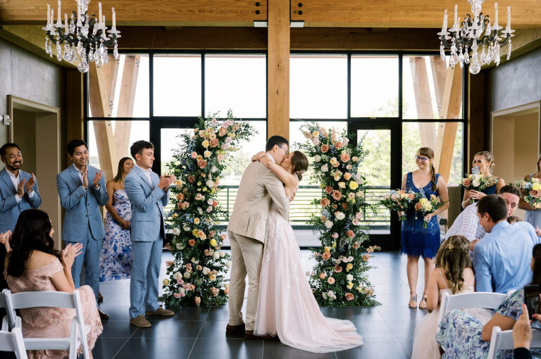 Leah and Kevin’s wedding was nothing short of enchanting—fitting for two fellow Harry Potter fans! From the emotional first look to their joyous celebration surrounded by family and friends, their special day was filled with love, laughter, and memorable moments.
Their day began early at The View at Lincoln Park, one of Jersey City’s newest and most unique wedding venues, part of the esteemed Landmark Venues collection. Nestled within the historic Lincoln Park, The View offers a modern yet timeless space with breathtaking scenery. The venue’s design is a stunning adaptive reuse of the original Lincoln Lodge (est. 1929), featuring preserved stone facades, timber beams, and antique fixtures. This blend of contemporary elegance and historic charm makes it a truly one-of-a-kind setting for weddings.
When I arrived, I was excited to explore the property and its surroundings. The View’s lush grounds, picturesque willow tree, and nearby landmarks, including the Lincoln Park Fountain, provide endless opportunities for stunning photographs. The morning was quiet as Leah and her bridesmaids arrived, carrying their dresses over their shoulders, and settled into the spacious bridal suite. Later, Kevin and their families arrived, and the anticipation began to build.
Leah and Kevin’s first look by the willow tree was a moment to remember. As the wind danced through the branches, tears filled Leah’s eyes as they read their vows to each other—an intimate, heartfelt exchange that perfectly set the tone for the day.
Guests began filling the chairs in Lincoln Room (the third-floor ceremony space), a modern area with large windows that allow natural light to flood in. This versatile room offers an elegant setting for ceremonies, with views of the surrounding park and cityscape. As Leah walked down the aisle with her father, they exchanged emotional glances, and the energy in the room was palpable.
The celebration moved to The Ballroom, The View’s stunning reception space. With its high ceilings, contemporary design, and floor-to-ceiling windows offering views of the park, the room was transformed into the perfect party atmosphere. Guests cheered as Leah and Kevin made their grand entrance, and their first dance kicked off an evening of fun, laughter, and memories.
Before the day concluded, Kevin had a special request for a photo by the Lincoln Park Fountain, a highlight of the park’s charm. We strolled over with Leah and Kevin to capture some magical portraits by the water. One of the great things about daytime weddings at The View is the ample natural light, ensuring we had beautiful lighting for photos even after the reception.
Leah and Kevin’s wedding was a joy to photograph, and The View at Lincoln Park provided the perfect backdrop for their unforgettable day. Congratulations to the happy couple—I’m so grateful to have been part of your story!
Leah and Kevin's The View at Lincoln Park Jersey City NJ documented by Karis from Hey Karis New York, Brooklyn, Hudson Valley NY and Catskills NY and NJ Wedding and NYC Elopement Photographer.
