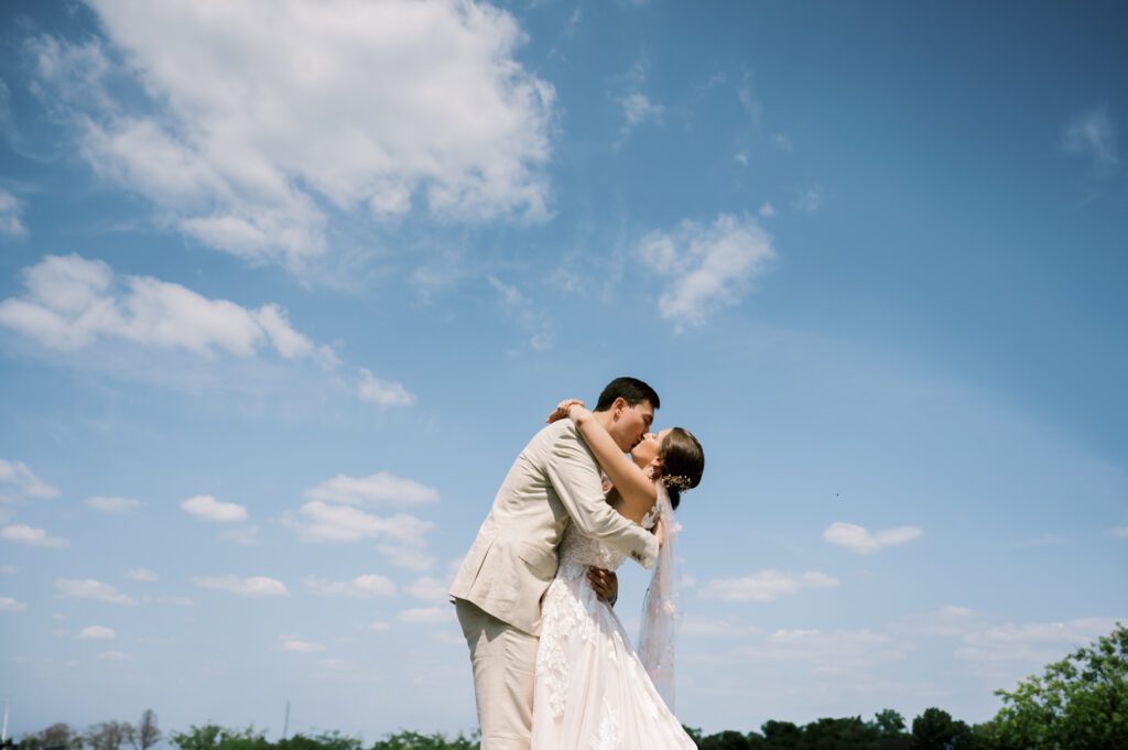 Leah and Kevin’s wedding was nothing short of enchanting—fitting for two fellow Harry Potter fans! From the emotional first look to their joyous celebration surrounded by family and friends, their special day was filled with love, laughter, and memorable moments.
Their day began early at The View at Lincoln Park, one of Jersey City’s newest and most unique wedding venues, part of the esteemed Landmark Venues collection. Nestled within the historic Lincoln Park, The View offers a modern yet timeless space with breathtaking scenery. The venue’s design is a stunning adaptive reuse of the original Lincoln Lodge (est. 1929), featuring preserved stone facades, timber beams, and antique fixtures. This blend of contemporary elegance and historic charm makes it a truly one-of-a-kind setting for weddings.
When I arrived, I was excited to explore the property and its surroundings. The View’s lush grounds, picturesque willow tree, and nearby landmarks, including the Lincoln Park Fountain, provide endless opportunities for stunning photographs. The morning was quiet as Leah and her bridesmaids arrived, carrying their dresses over their shoulders, and settled into the spacious bridal suite. Later, Kevin and their families arrived, and the anticipation began to build.
Leah and Kevin’s first look by the willow tree was a moment to remember. As the wind danced through the branches, tears filled Leah’s eyes as they read their vows to each other—an intimate, heartfelt exchange that perfectly set the tone for the day.
Guests began filling the chairs in Lincoln Room (the third-floor ceremony space), a modern area with large windows that allow natural light to flood in. This versatile room offers an elegant setting for ceremonies, with views of the surrounding park and cityscape. As Leah walked down the aisle with her father, they exchanged emotional glances, and the energy in the room was palpable.
The celebration moved to The Ballroom, The View’s stunning reception space. With its high ceilings, contemporary design, and floor-to-ceiling windows offering views of the park, the room was transformed into the perfect party atmosphere. Guests cheered as Leah and Kevin made their grand entrance, and their first dance kicked off an evening of fun, laughter, and memories.
Before the day concluded, Kevin had a special request for a photo by the Lincoln Park Fountain, a highlight of the park’s charm. We strolled over with Leah and Kevin to capture some magical portraits by the water. One of the great things about daytime weddings at The View is the ample natural light, ensuring we had beautiful lighting for photos even after the reception.
Leah and Kevin’s wedding was a joy to photograph, and The View at Lincoln Park provided the perfect backdrop for their unforgettable day. Congratulations to the happy couple—I’m so grateful to have been part of your story!
Leah and Kevin's The View at Lincoln Park Jersey City NJ documented by Karis from Hey Karis New York, Brooklyn, Hudson Valley NY and Catskills NY and NJ Wedding and NYC Elopement Photographer.
