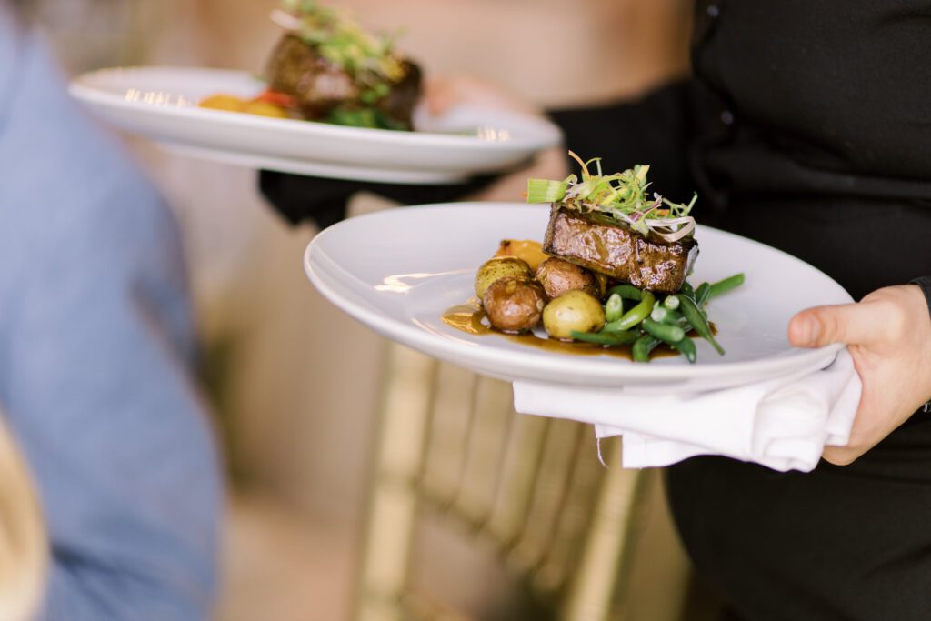 Leah and Kevin’s wedding was nothing short of enchanting—fitting for two fellow Harry Potter fans! From the emotional first look to their joyous celebration surrounded by family and friends, their special day was filled with love, laughter, and memorable moments.
Their day began early at The View at Lincoln Park, one of Jersey City’s newest and most unique wedding venues, part of the esteemed Landmark Venues collection. Nestled within the historic Lincoln Park, The View offers a modern yet timeless space with breathtaking scenery. The venue’s design is a stunning adaptive reuse of the original Lincoln Lodge (est. 1929), featuring preserved stone facades, timber beams, and antique fixtures. This blend of contemporary elegance and historic charm makes it a truly one-of-a-kind setting for weddings.
When I arrived, I was excited to explore the property and its surroundings. The View’s lush grounds, picturesque willow tree, and nearby landmarks, including the Lincoln Park Fountain, provide endless opportunities for stunning photographs. The morning was quiet as Leah and her bridesmaids arrived, carrying their dresses over their shoulders, and settled into the spacious bridal suite. Later, Kevin and their families arrived, and the anticipation began to build.
Leah and Kevin’s first look by the willow tree was a moment to remember. As the wind danced through the branches, tears filled Leah’s eyes as they read their vows to each other—an intimate, heartfelt exchange that perfectly set the tone for the day.
Guests began filling the chairs in Lincoln Room (the third-floor ceremony space), a modern area with large windows that allow natural light to flood in. This versatile room offers an elegant setting for ceremonies, with views of the surrounding park and cityscape. As Leah walked down the aisle with her father, they exchanged emotional glances, and the energy in the room was palpable.
The celebration moved to The Ballroom, The View’s stunning reception space. With its high ceilings, contemporary design, and floor-to-ceiling windows offering views of the park, the room was transformed into the perfect party atmosphere. Guests cheered as Leah and Kevin made their grand entrance, and their first dance kicked off an evening of fun, laughter, and memories.
Before the day concluded, Kevin had a special request for a photo by the Lincoln Park Fountain, a highlight of the park’s charm. We strolled over with Leah and Kevin to capture some magical portraits by the water. One of the great things about daytime weddings at The View is the ample natural light, ensuring we had beautiful lighting for photos even after the reception.
Leah and Kevin’s wedding was a joy to photograph, and The View at Lincoln Park provided the perfect backdrop for their unforgettable day. Congratulations to the happy couple—I’m so grateful to have been part of your story!
Leah and Kevin's The View at Lincoln Park Jersey City NJ documented by Karis from Hey Karis New York, Brooklyn, Hudson Valley NY and Catskills NY and NJ Wedding and NYC Elopement Photographer.
