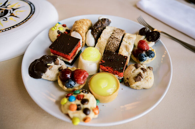 Leah and Kevin’s wedding was nothing short of enchanting—fitting for two fellow Harry Potter fans! From the emotional first look to their joyous celebration surrounded by family and friends, their special day was filled with love, laughter, and memorable moments.
Their day began early at The View at Lincoln Park, one of Jersey City’s newest and most unique wedding venues, part of the esteemed Landmark Venues collection. Nestled within the historic Lincoln Park, The View offers a modern yet timeless space with breathtaking scenery. The venue’s design is a stunning adaptive reuse of the original Lincoln Lodge (est. 1929), featuring preserved stone facades, timber beams, and antique fixtures. This blend of contemporary elegance and historic charm makes it a truly one-of-a-kind setting for weddings.
When I arrived, I was excited to explore the property and its surroundings. The View’s lush grounds, picturesque willow tree, and nearby landmarks, including the Lincoln Park Fountain, provide endless opportunities for stunning photographs. The morning was quiet as Leah and her bridesmaids arrived, carrying their dresses over their shoulders, and settled into the spacious bridal suite. Later, Kevin and their families arrived, and the anticipation began to build.
Leah and Kevin’s first look by the willow tree was a moment to remember. As the wind danced through the branches, tears filled Leah’s eyes as they read their vows to each other—an intimate, heartfelt exchange that perfectly set the tone for the day.
Guests began filling the chairs in Lincoln Room (the third-floor ceremony space), a modern area with large windows that allow natural light to flood in. This versatile room offers an elegant setting for ceremonies, with views of the surrounding park and cityscape. As Leah walked down the aisle with her father, they exchanged emotional glances, and the energy in the room was palpable.
The celebration moved to The Ballroom, The View’s stunning reception space. With its high ceilings, contemporary design, and floor-to-ceiling windows offering views of the park, the room was transformed into the perfect party atmosphere. Guests cheered as Leah and Kevin made their grand entrance, and their first dance kicked off an evening of fun, laughter, and memories.
Before the day concluded, Kevin had a special request for a photo by the Lincoln Park Fountain, a highlight of the park’s charm. We strolled over with Leah and Kevin to capture some magical portraits by the water. One of the great things about daytime weddings at The View is the ample natural light, ensuring we had beautiful lighting for photos even after the reception.
Leah and Kevin’s wedding was a joy to photograph, and The View at Lincoln Park provided the perfect backdrop for their unforgettable day. Congratulations to the happy couple—I’m so grateful to have been part of your story!
Leah and Kevin's The View at Lincoln Park Jersey City NJ documented by Karis from Hey Karis New York, Brooklyn, Hudson Valley NY and Catskills NY and NJ Wedding and NYC Elopement Photographer.
