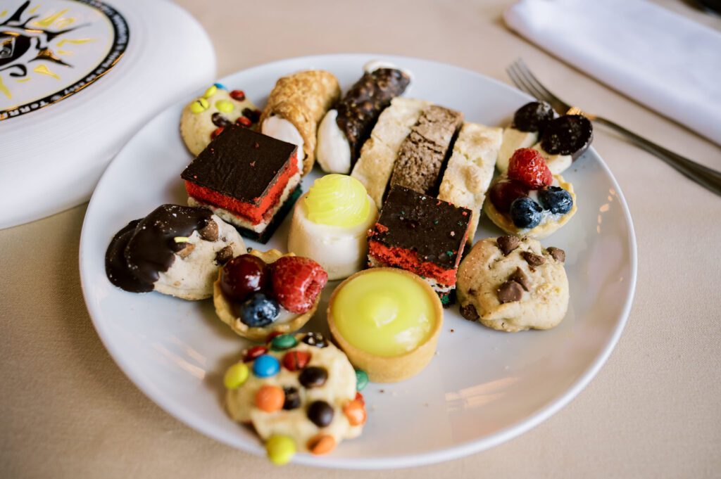 Leah and Kevin’s wedding was nothing short of enchanting—fitting for two fellow Harry Potter fans! From the emotional first look to their joyous celebration surrounded by family and friends, their special day was filled with love, laughter, and memorable moments.
Their day began early at The View at Lincoln Park, one of Jersey City’s newest and most unique wedding venues, part of the esteemed Landmark Venues collection. Nestled within the historic Lincoln Park, The View offers a modern yet timeless space with breathtaking scenery. The venue’s design is a stunning adaptive reuse of the original Lincoln Lodge (est. 1929), featuring preserved stone facades, timber beams, and antique fixtures. This blend of contemporary elegance and historic charm makes it a truly one-of-a-kind setting for weddings.
When I arrived, I was excited to explore the property and its surroundings. The View’s lush grounds, picturesque willow tree, and nearby landmarks, including the Lincoln Park Fountain, provide endless opportunities for stunning photographs. The morning was quiet as Leah and her bridesmaids arrived, carrying their dresses over their shoulders, and settled into the spacious bridal suite. Later, Kevin and their families arrived, and the anticipation began to build.
Leah and Kevin’s first look by the willow tree was a moment to remember. As the wind danced through the branches, tears filled Leah’s eyes as they read their vows to each other—an intimate, heartfelt exchange that perfectly set the tone for the day.
Guests began filling the chairs in Lincoln Room (the third-floor ceremony space), a modern area with large windows that allow natural light to flood in. This versatile room offers an elegant setting for ceremonies, with views of the surrounding park and cityscape. As Leah walked down the aisle with her father, they exchanged emotional glances, and the energy in the room was palpable.
The celebration moved to The Ballroom, The View’s stunning reception space. With its high ceilings, contemporary design, and floor-to-ceiling windows offering views of the park, the room was transformed into the perfect party atmosphere. Guests cheered as Leah and Kevin made their grand entrance, and their first dance kicked off an evening of fun, laughter, and memories.
Before the day concluded, Kevin had a special request for a photo by the Lincoln Park Fountain, a highlight of the park’s charm. We strolled over with Leah and Kevin to capture some magical portraits by the water. One of the great things about daytime weddings at The View is the ample natural light, ensuring we had beautiful lighting for photos even after the reception.
Leah and Kevin’s wedding was a joy to photograph, and The View at Lincoln Park provided the perfect backdrop for their unforgettable day. Congratulations to the happy couple—I’m so grateful to have been part of your story!
Leah and Kevin's The View at Lincoln Park Jersey City NJ documented by Karis from Hey Karis New York, Brooklyn, Hudson Valley NY and Catskills NY and NJ Wedding and NYC Elopement Photographer.
