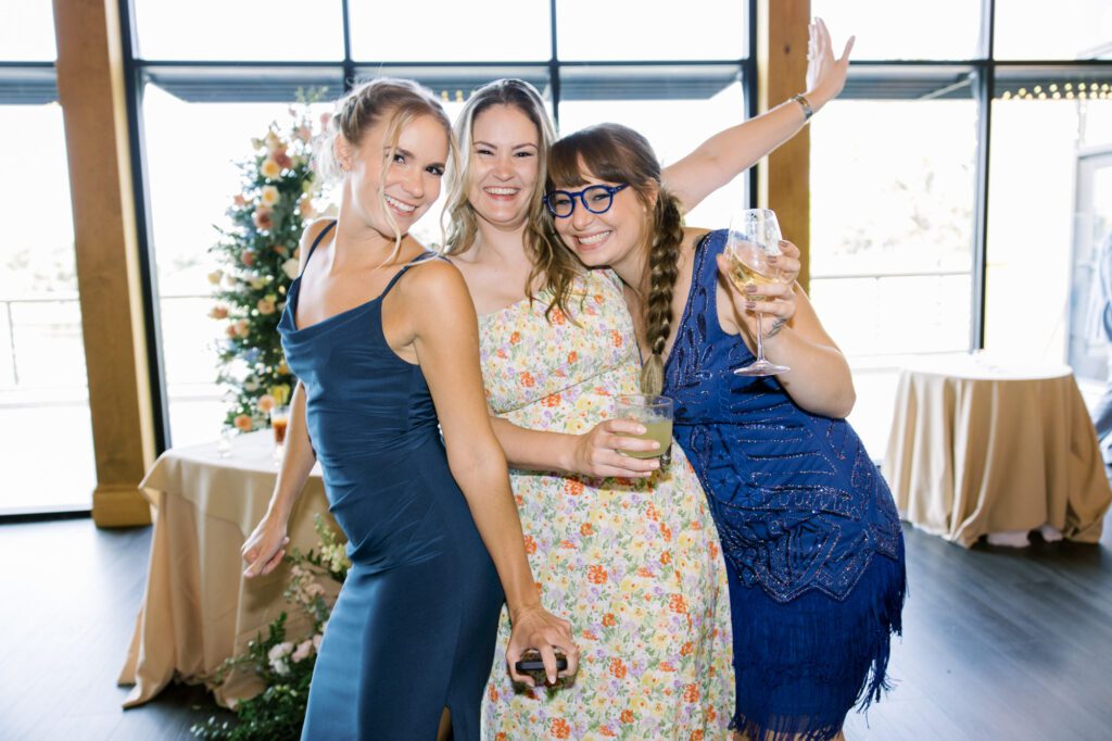 Leah and Kevin’s wedding was nothing short of enchanting—fitting for two fellow Harry Potter fans! From the emotional first look to their joyous celebration surrounded by family and friends, their special day was filled with love, laughter, and memorable moments.
Their day began early at The View at Lincoln Park, one of Jersey City’s newest and most unique wedding venues, part of the esteemed Landmark Venues collection. Nestled within the historic Lincoln Park, The View offers a modern yet timeless space with breathtaking scenery. The venue’s design is a stunning adaptive reuse of the original Lincoln Lodge (est. 1929), featuring preserved stone facades, timber beams, and antique fixtures. This blend of contemporary elegance and historic charm makes it a truly one-of-a-kind setting for weddings.
When I arrived, I was excited to explore the property and its surroundings. The View’s lush grounds, picturesque willow tree, and nearby landmarks, including the Lincoln Park Fountain, provide endless opportunities for stunning photographs. The morning was quiet as Leah and her bridesmaids arrived, carrying their dresses over their shoulders, and settled into the spacious bridal suite. Later, Kevin and their families arrived, and the anticipation began to build.
Leah and Kevin’s first look by the willow tree was a moment to remember. As the wind danced through the branches, tears filled Leah’s eyes as they read their vows to each other—an intimate, heartfelt exchange that perfectly set the tone for the day.
Guests began filling the chairs in Lincoln Room (the third-floor ceremony space), a modern area with large windows that allow natural light to flood in. This versatile room offers an elegant setting for ceremonies, with views of the surrounding park and cityscape. As Leah walked down the aisle with her father, they exchanged emotional glances, and the energy in the room was palpable.
The celebration moved to The Ballroom, The View’s stunning reception space. With its high ceilings, contemporary design, and floor-to-ceiling windows offering views of the park, the room was transformed into the perfect party atmosphere. Guests cheered as Leah and Kevin made their grand entrance, and their first dance kicked off an evening of fun, laughter, and memories.
Before the day concluded, Kevin had a special request for a photo by the Lincoln Park Fountain, a highlight of the park’s charm. We strolled over with Leah and Kevin to capture some magical portraits by the water. One of the great things about daytime weddings at The View is the ample natural light, ensuring we had beautiful lighting for photos even after the reception.
Leah and Kevin’s wedding was a joy to photograph, and The View at Lincoln Park provided the perfect backdrop for their unforgettable day. Congratulations to the happy couple—I’m so grateful to have been part of your story!
Leah and Kevin's The View at Lincoln Park Jersey City NJ documented by Karis from Hey Karis New York, Brooklyn, Hudson Valley NY and Catskills NY and NJ Wedding and NYC Elopement Photographer.
