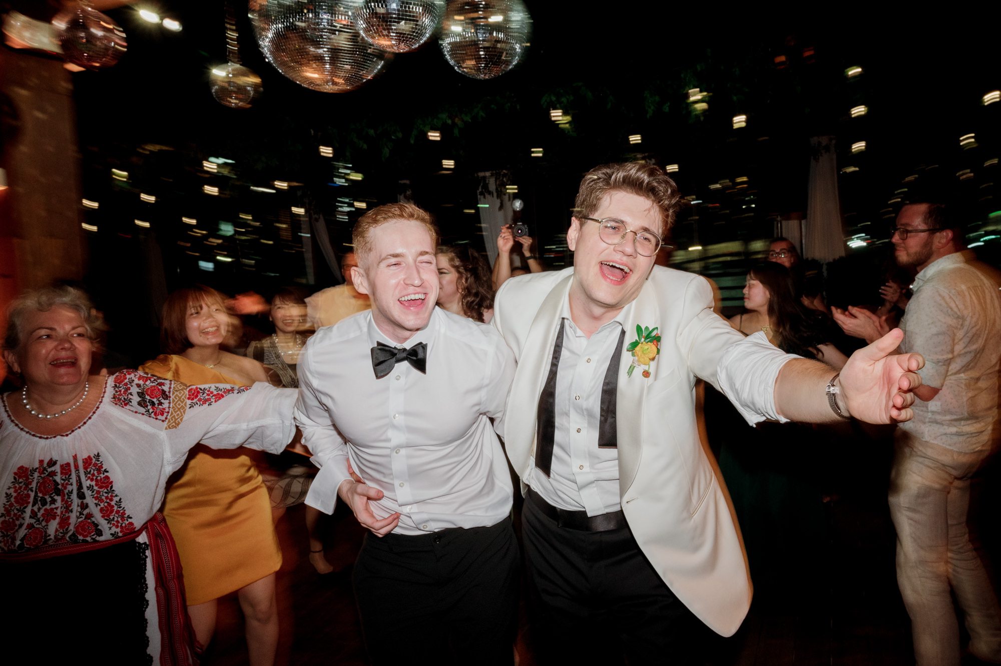 So excited for Erika and Andrei’s wedding day at The Box House Hotel in Brooklyn, NY. This boutique hotel had been on my bucket list for a while, and it did not disappoint! With its unique design, vibrant personality, and incredible rooftop views, The Box House Hotel provided the perfect setting for unique wedding celebration.
The day began with Erika and Andrei getting ready in their respective rooms, surrounded by friends and loved ones. One of the standout features of The Box House Hotel is its boutique charm and eclectic style, blending industrial elements with a cozy, artistic vibe. Erika’s bridal suite, with its floor-to-ceiling windows, was filled with natural light, making it a dream space for capturing those intimate getting-ready moments.
Once everyone was ready, Andrei headed to the rooftop, eagerly waiting to see his bride for the first time. As Erika gracefully approached, her dress swaying in the breeze, Andrei turned around, completely captivated. The two shared a private, heartfelt moment, whispering sweet words to each other, before we moved on to family photos.
The Box House Hotel’s location on a quiet Brooklyn street was perfect for photos. We captured their formal family and bridal party shots right in front of the hotel, showcasing its charming exterior. Then came a unique tradition I’d never witnessed before in my 14+ years of wedding photography! Erika and Andrei brought out a bucket of water filled with coins, and as guests cheered, Erika kicked the bucket as far as she could—a cultural ritual symbolizing good luck and prosperity. It was a joy to photograph and such a fun, memorable moment!
Afterward, we made our way back to the 10,000-square-foot rooftop, which offers unparalleled panoramic views of Manhattan, Brooklyn, and Long Island City. It’s a breathtaking setting for any wedding, leaving guests in awe of the skyline. Friends and family traveled from near and far, including Japan and Romania, to celebrate Erika and Andrei. To honor Erika's Japanese roots, Erika and Andrei incorporated a Japanese tea ceremony officiated by Erika's cousins from Japan. The rooftop was filled with laughter, love, and joy as the ceremony unfolded under the open sky.
As the sun set, the magic of the evening truly came alive. The city skyline twinkled with lights, and the dark sky sparkled with stars. Erika and Andrei danced, laughed, and celebrated late into the night, surrounded by their closest friends and family.
The Box House Hotel is a one-of-a-kind venue, blending urban sophistication with artistic charm. Its rooftop views, boutique-style accommodations, and vibrant atmosphere make it a perfect choice for couples looking to create a unique and unforgettable wedding experience.
Erika and Andrei, thank you for letting me be part of your incredible day. Wishing you a lifetime of love, happiness, and adventure!
Erika and Andrei The Box House Hotel Brooklyn NY Wedding documented by Karis from Hey Karis New York, Brooklyn, Hudson Valley NY and Catskills NY and NJ Wedding and NYC Elopement Photographer.