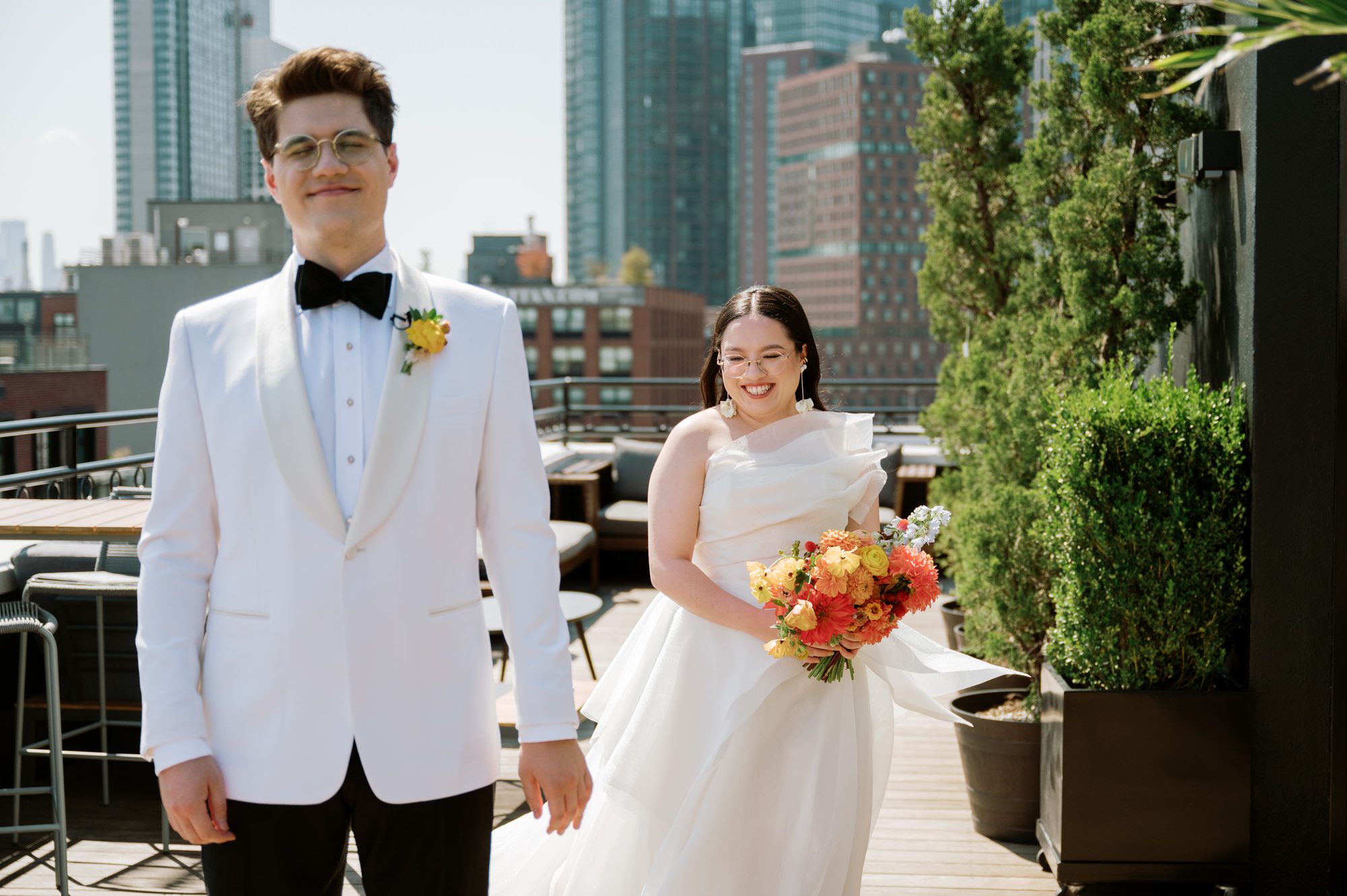 So excited for Erika and Andrei’s wedding day at The Box House Hotel in Brooklyn, NY. This boutique hotel had been on my bucket list for a while, and it did not disappoint! With its unique design, vibrant personality, and incredible rooftop views, The Box House Hotel provided the perfect setting for unique wedding celebration.
The day began with Erika and Andrei getting ready in their respective rooms, surrounded by friends and loved ones. One of the standout features of The Box House Hotel is its boutique charm and eclectic style, blending industrial elements with a cozy, artistic vibe. Erika’s bridal suite, with its floor-to-ceiling windows, was filled with natural light, making it a dream space for capturing those intimate getting-ready moments.
Once everyone was ready, Andrei headed to the rooftop, eagerly waiting to see his bride for the first time. As Erika gracefully approached, her dress swaying in the breeze, Andrei turned around, completely captivated. The two shared a private, heartfelt moment, whispering sweet words to each other, before we moved on to family photos.
The Box House Hotel’s location on a quiet Brooklyn street was perfect for photos. We captured their formal family and bridal party shots right in front of the hotel, showcasing its charming exterior. Then came a unique tradition I’d never witnessed before in my 14+ years of wedding photography! Erika and Andrei brought out a bucket of water filled with coins, and as guests cheered, Erika kicked the bucket as far as she could—a cultural ritual symbolizing good luck and prosperity. It was a joy to photograph and such a fun, memorable moment!
Afterward, we made our way back to the 10,000-square-foot rooftop, which offers unparalleled panoramic views of Manhattan, Brooklyn, and Long Island City. It’s a breathtaking setting for any wedding, leaving guests in awe of the skyline. Friends and family traveled from near and far, including Japan and Romania, to celebrate Erika and Andrei. To honor Erika's Japanese roots, Erika and Andrei incorporated a Japanese tea ceremony officiated by Erika's cousins from Japan. The rooftop was filled with laughter, love, and joy as the ceremony unfolded under the open sky.
As the sun set, the magic of the evening truly came alive. The city skyline twinkled with lights, and the dark sky sparkled with stars. Erika and Andrei danced, laughed, and celebrated late into the night, surrounded by their closest friends and family.
The Box House Hotel is a one-of-a-kind venue, blending urban sophistication with artistic charm. Its rooftop views, boutique-style accommodations, and vibrant atmosphere make it a perfect choice for couples looking to create a unique and unforgettable wedding experience.
Erika and Andrei, thank you for letting me be part of your incredible day. Wishing you a lifetime of love, happiness, and adventure!
Erika and Andrei The Box House Hotel Brooklyn NY Wedding documented by Karis from Hey Karis New York, Brooklyn, Hudson Valley NY and Catskills NY and NJ Wedding and NYC Elopement Photographer.