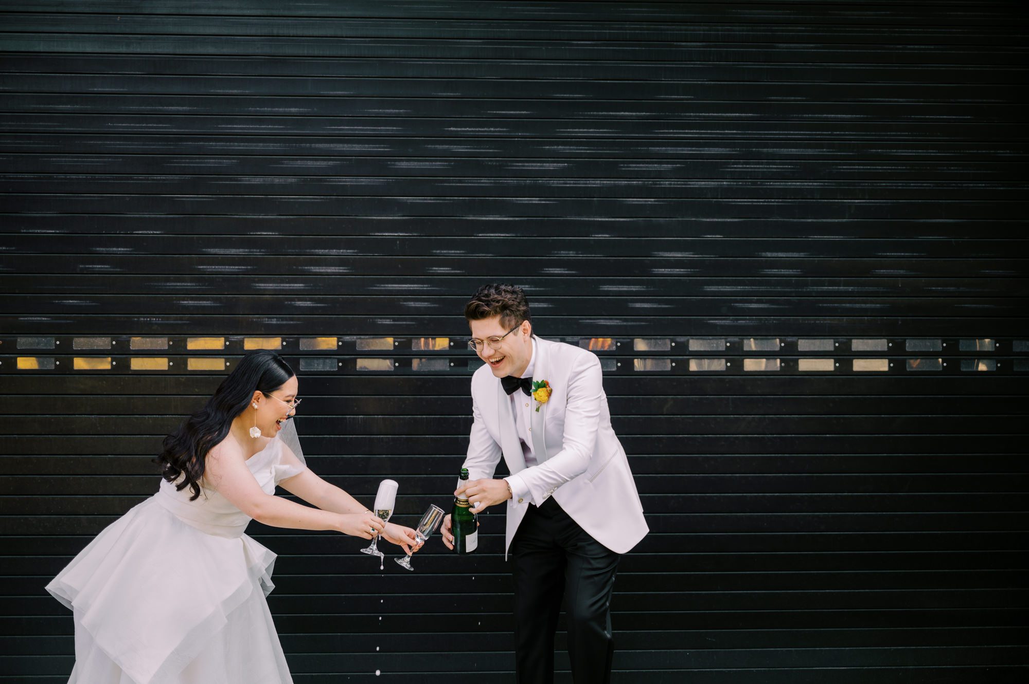 So excited for Erika and Andrei’s wedding day at The Box House Hotel in Brooklyn, NY. This boutique hotel had been on my bucket list for a while, and it did not disappoint! With its unique design, vibrant personality, and incredible rooftop views, The Box House Hotel provided the perfect setting for unique wedding celebration.
The day began with Erika and Andrei getting ready in their respective rooms, surrounded by friends and loved ones. One of the standout features of The Box House Hotel is its boutique charm and eclectic style, blending industrial elements with a cozy, artistic vibe. Erika’s bridal suite, with its floor-to-ceiling windows, was filled with natural light, making it a dream space for capturing those intimate getting-ready moments.
Once everyone was ready, Andrei headed to the rooftop, eagerly waiting to see his bride for the first time. As Erika gracefully approached, her dress swaying in the breeze, Andrei turned around, completely captivated. The two shared a private, heartfelt moment, whispering sweet words to each other, before we moved on to family photos.
The Box House Hotel’s location on a quiet Brooklyn street was perfect for photos. We captured their formal family and bridal party shots right in front of the hotel, showcasing its charming exterior. Then came a unique tradition I’d never witnessed before in my 14+ years of wedding photography! Erika and Andrei brought out a bucket of water filled with coins, and as guests cheered, Erika kicked the bucket as far as she could—a cultural ritual symbolizing good luck and prosperity. It was a joy to photograph and such a fun, memorable moment!
Afterward, we made our way back to the 10,000-square-foot rooftop, which offers unparalleled panoramic views of Manhattan, Brooklyn, and Long Island City. It’s a breathtaking setting for any wedding, leaving guests in awe of the skyline. Friends and family traveled from near and far, including Japan and Romania, to celebrate Erika and Andrei. To honor Erika's Japanese roots, Erika and Andrei incorporated a Japanese tea ceremony officiated by Erika's cousins from Japan. The rooftop was filled with laughter, love, and joy as the ceremony unfolded under the open sky.
As the sun set, the magic of the evening truly came alive. The city skyline twinkled with lights, and the dark sky sparkled with stars. Erika and Andrei danced, laughed, and celebrated late into the night, surrounded by their closest friends and family.
The Box House Hotel is a one-of-a-kind venue, blending urban sophistication with artistic charm. Its rooftop views, boutique-style accommodations, and vibrant atmosphere make it a perfect choice for couples looking to create a unique and unforgettable wedding experience.
Erika and Andrei, thank you for letting me be part of your incredible day. Wishing you a lifetime of love, happiness, and adventure!
Erika and Andrei The Box House Hotel Brooklyn NY Wedding documented by Karis from Hey Karis New York, Brooklyn, Hudson Valley NY and Catskills NY and NJ Wedding and NYC Elopement Photographer.