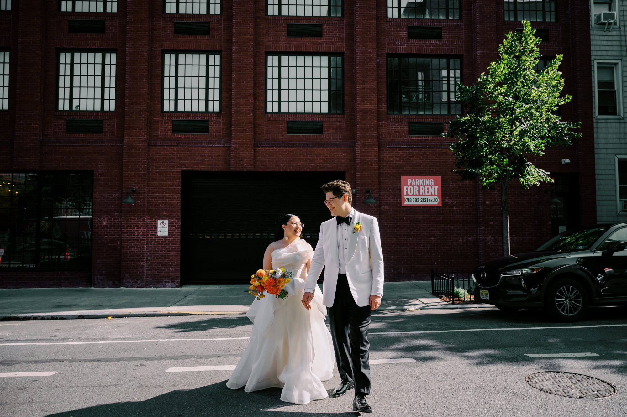 So excited for Erika and Andrei’s wedding day at The Box House Hotel in Brooklyn, NY. This boutique hotel had been on my bucket list for a while, and it did not disappoint! With its unique design, vibrant personality, and incredible rooftop views, The Box House Hotel provided the perfect setting for unique wedding celebration.
The day began with Erika and Andrei getting ready in their respective rooms, surrounded by friends and loved ones. One of the standout features of The Box House Hotel is its boutique charm and eclectic style, blending industrial elements with a cozy, artistic vibe. Erika’s bridal suite, with its floor-to-ceiling windows, was filled with natural light, making it a dream space for capturing those intimate getting-ready moments.
Once everyone was ready, Andrei headed to the rooftop, eagerly waiting to see his bride for the first time. As Erika gracefully approached, her dress swaying in the breeze, Andrei turned around, completely captivated. The two shared a private, heartfelt moment, whispering sweet words to each other, before we moved on to family photos.
The Box House Hotel’s location on a quiet Brooklyn street was perfect for photos. We captured their formal family and bridal party shots right in front of the hotel, showcasing its charming exterior. Then came a unique tradition I’d never witnessed before in my 14+ years of wedding photography! Erika and Andrei brought out a bucket of water filled with coins, and as guests cheered, Erika kicked the bucket as far as she could—a cultural ritual symbolizing good luck and prosperity. It was a joy to photograph and such a fun, memorable moment!
Afterward, we made our way back to the 10,000-square-foot rooftop, which offers unparalleled panoramic views of Manhattan, Brooklyn, and Long Island City. It’s a breathtaking setting for any wedding, leaving guests in awe of the skyline. Friends and family traveled from near and far, including Japan and Romania, to celebrate Erika and Andrei. To honor Erika's Japanese roots, Erika and Andrei incorporated a Japanese tea ceremony officiated by Erika's cousins from Japan. The rooftop was filled with laughter, love, and joy as the ceremony unfolded under the open sky.
As the sun set, the magic of the evening truly came alive. The city skyline twinkled with lights, and the dark sky sparkled with stars. Erika and Andrei danced, laughed, and celebrated late into the night, surrounded by their closest friends and family.
The Box House Hotel is a one-of-a-kind venue, blending urban sophistication with artistic charm. Its rooftop views, boutique-style accommodations, and vibrant atmosphere make it a perfect choice for couples looking to create a unique and unforgettable wedding experience.
Erika and Andrei, thank you for letting me be part of your incredible day. Wishing you a lifetime of love, happiness, and adventure!
Erika and Andrei The Box House Hotel Brooklyn NY Wedding documented by Karis from Hey Karis New York, Brooklyn, Hudson Valley NY and Catskills NY and NJ Wedding and NYC Elopement Photographer.