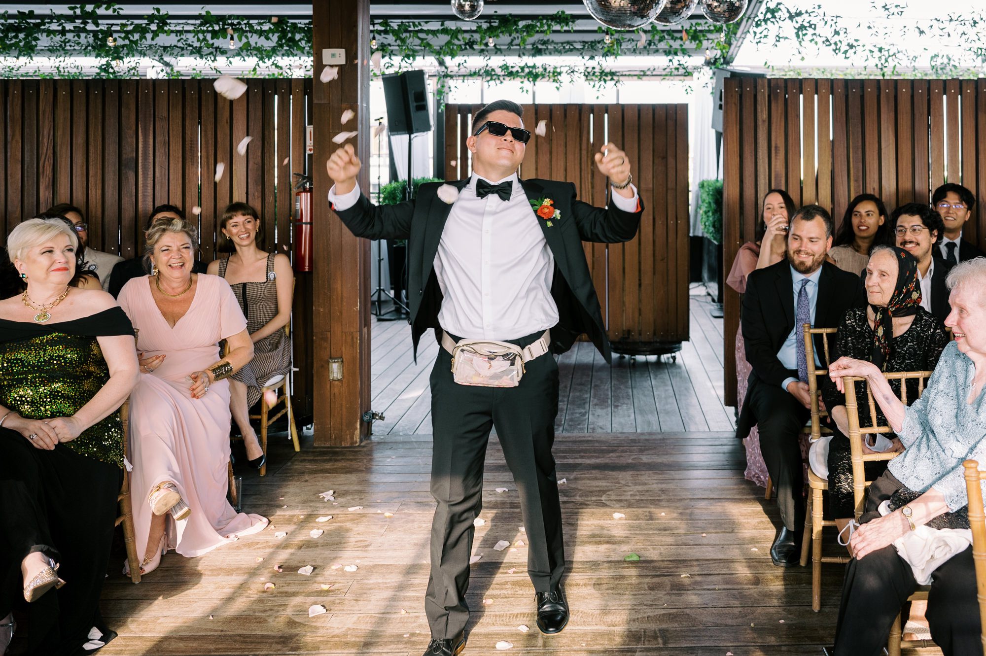 So excited for Erika and Andrei’s wedding day at The Box House Hotel in Brooklyn, NY. This boutique hotel had been on my bucket list for a while, and it did not disappoint! With its unique design, vibrant personality, and incredible rooftop views, The Box House Hotel provided the perfect setting for unique wedding celebration.
The day began with Erika and Andrei getting ready in their respective rooms, surrounded by friends and loved ones. One of the standout features of The Box House Hotel is its boutique charm and eclectic style, blending industrial elements with a cozy, artistic vibe. Erika’s bridal suite, with its floor-to-ceiling windows, was filled with natural light, making it a dream space for capturing those intimate getting-ready moments.
Once everyone was ready, Andrei headed to the rooftop, eagerly waiting to see his bride for the first time. As Erika gracefully approached, her dress swaying in the breeze, Andrei turned around, completely captivated. The two shared a private, heartfelt moment, whispering sweet words to each other, before we moved on to family photos.
The Box House Hotel’s location on a quiet Brooklyn street was perfect for photos. We captured their formal family and bridal party shots right in front of the hotel, showcasing its charming exterior. Then came a unique tradition I’d never witnessed before in my 14+ years of wedding photography! Erika and Andrei brought out a bucket of water filled with coins, and as guests cheered, Erika kicked the bucket as far as she could—a cultural ritual symbolizing good luck and prosperity. It was a joy to photograph and such a fun, memorable moment!
Afterward, we made our way back to the 10,000-square-foot rooftop, which offers unparalleled panoramic views of Manhattan, Brooklyn, and Long Island City. It’s a breathtaking setting for any wedding, leaving guests in awe of the skyline. Friends and family traveled from near and far, including Japan and Romania, to celebrate Erika and Andrei. To honor Erika's Japanese roots, Erika and Andrei incorporated a Japanese tea ceremony officiated by Erika's cousins from Japan. The rooftop was filled with laughter, love, and joy as the ceremony unfolded under the open sky.
As the sun set, the magic of the evening truly came alive. The city skyline twinkled with lights, and the dark sky sparkled with stars. Erika and Andrei danced, laughed, and celebrated late into the night, surrounded by their closest friends and family.
The Box House Hotel is a one-of-a-kind venue, blending urban sophistication with artistic charm. Its rooftop views, boutique-style accommodations, and vibrant atmosphere make it a perfect choice for couples looking to create a unique and unforgettable wedding experience.
Erika and Andrei, thank you for letting me be part of your incredible day. Wishing you a lifetime of love, happiness, and adventure!
Erika and Andrei The Box House Hotel Brooklyn NY Wedding documented by Karis from Hey Karis New York, Brooklyn, Hudson Valley NY and Catskills NY and NJ Wedding and NYC Elopement Photographer.