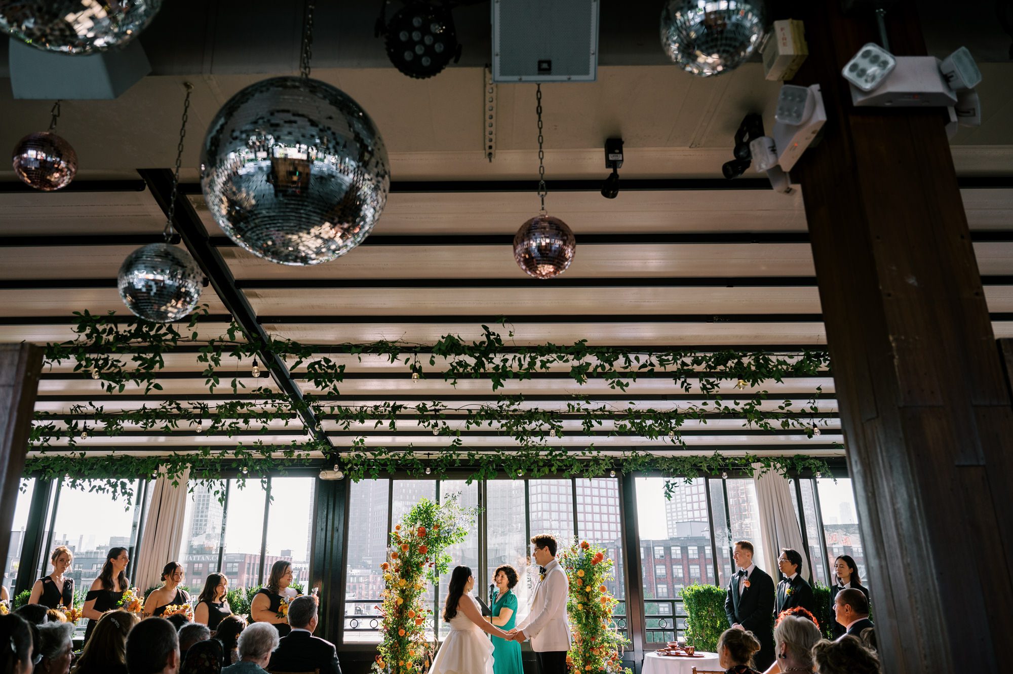 So excited for Erika and Andrei’s wedding day at The Box House Hotel in Brooklyn, NY. This boutique hotel had been on my bucket list for a while, and it did not disappoint! With its unique design, vibrant personality, and incredible rooftop views, The Box House Hotel provided the perfect setting for unique wedding celebration.
The day began with Erika and Andrei getting ready in their respective rooms, surrounded by friends and loved ones. One of the standout features of The Box House Hotel is its boutique charm and eclectic style, blending industrial elements with a cozy, artistic vibe. Erika’s bridal suite, with its floor-to-ceiling windows, was filled with natural light, making it a dream space for capturing those intimate getting-ready moments.
Once everyone was ready, Andrei headed to the rooftop, eagerly waiting to see his bride for the first time. As Erika gracefully approached, her dress swaying in the breeze, Andrei turned around, completely captivated. The two shared a private, heartfelt moment, whispering sweet words to each other, before we moved on to family photos.
The Box House Hotel’s location on a quiet Brooklyn street was perfect for photos. We captured their formal family and bridal party shots right in front of the hotel, showcasing its charming exterior. Then came a unique tradition I’d never witnessed before in my 14+ years of wedding photography! Erika and Andrei brought out a bucket of water filled with coins, and as guests cheered, Erika kicked the bucket as far as she could—a cultural ritual symbolizing good luck and prosperity. It was a joy to photograph and such a fun, memorable moment!
Afterward, we made our way back to the 10,000-square-foot rooftop, which offers unparalleled panoramic views of Manhattan, Brooklyn, and Long Island City. It’s a breathtaking setting for any wedding, leaving guests in awe of the skyline. Friends and family traveled from near and far, including Japan and Romania, to celebrate Erika and Andrei. To honor Erika's Japanese roots, Erika and Andrei incorporated a Japanese tea ceremony officiated by Erika's cousins from Japan. The rooftop was filled with laughter, love, and joy as the ceremony unfolded under the open sky.
As the sun set, the magic of the evening truly came alive. The city skyline twinkled with lights, and the dark sky sparkled with stars. Erika and Andrei danced, laughed, and celebrated late into the night, surrounded by their closest friends and family.
The Box House Hotel is a one-of-a-kind venue, blending urban sophistication with artistic charm. Its rooftop views, boutique-style accommodations, and vibrant atmosphere make it a perfect choice for couples looking to create a unique and unforgettable wedding experience.
Erika and Andrei, thank you for letting me be part of your incredible day. Wishing you a lifetime of love, happiness, and adventure!
Erika and Andrei The Box House Hotel Brooklyn NY Wedding documented by Karis from Hey Karis New York, Brooklyn, Hudson Valley NY and Catskills NY and NJ Wedding and NYC Elopement Photographer.