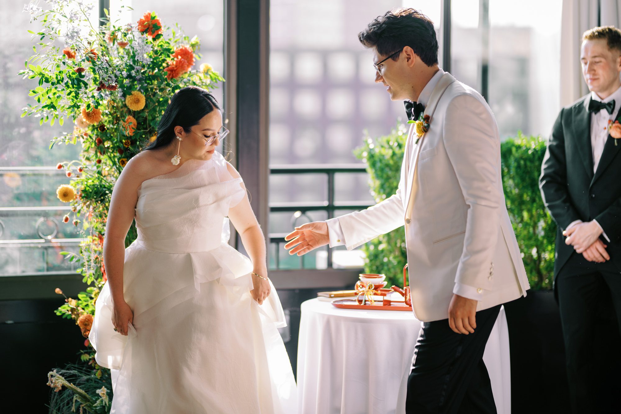 So excited for Erika and Andrei’s wedding day at The Box House Hotel in Brooklyn, NY. This boutique hotel had been on my bucket list for a while, and it did not disappoint! With its unique design, vibrant personality, and incredible rooftop views, The Box House Hotel provided the perfect setting for unique wedding celebration.
The day began with Erika and Andrei getting ready in their respective rooms, surrounded by friends and loved ones. One of the standout features of The Box House Hotel is its boutique charm and eclectic style, blending industrial elements with a cozy, artistic vibe. Erika’s bridal suite, with its floor-to-ceiling windows, was filled with natural light, making it a dream space for capturing those intimate getting-ready moments.
Once everyone was ready, Andrei headed to the rooftop, eagerly waiting to see his bride for the first time. As Erika gracefully approached, her dress swaying in the breeze, Andrei turned around, completely captivated. The two shared a private, heartfelt moment, whispering sweet words to each other, before we moved on to family photos.
The Box House Hotel’s location on a quiet Brooklyn street was perfect for photos. We captured their formal family and bridal party shots right in front of the hotel, showcasing its charming exterior. Then came a unique tradition I’d never witnessed before in my 14+ years of wedding photography! Erika and Andrei brought out a bucket of water filled with coins, and as guests cheered, Erika kicked the bucket as far as she could—a cultural ritual symbolizing good luck and prosperity. It was a joy to photograph and such a fun, memorable moment!
Afterward, we made our way back to the 10,000-square-foot rooftop, which offers unparalleled panoramic views of Manhattan, Brooklyn, and Long Island City. It’s a breathtaking setting for any wedding, leaving guests in awe of the skyline. Friends and family traveled from near and far, including Japan and Romania, to celebrate Erika and Andrei. To honor Erika's Japanese roots, Erika and Andrei incorporated a Japanese tea ceremony officiated by Erika's cousins from Japan. The rooftop was filled with laughter, love, and joy as the ceremony unfolded under the open sky.
As the sun set, the magic of the evening truly came alive. The city skyline twinkled with lights, and the dark sky sparkled with stars. Erika and Andrei danced, laughed, and celebrated late into the night, surrounded by their closest friends and family.
The Box House Hotel is a one-of-a-kind venue, blending urban sophistication with artistic charm. Its rooftop views, boutique-style accommodations, and vibrant atmosphere make it a perfect choice for couples looking to create a unique and unforgettable wedding experience.
Erika and Andrei, thank you for letting me be part of your incredible day. Wishing you a lifetime of love, happiness, and adventure!
Erika and Andrei The Box House Hotel Brooklyn NY Wedding documented by Karis from Hey Karis New York, Brooklyn, Hudson Valley NY and Catskills NY and NJ Wedding and NYC Elopement Photographer.
