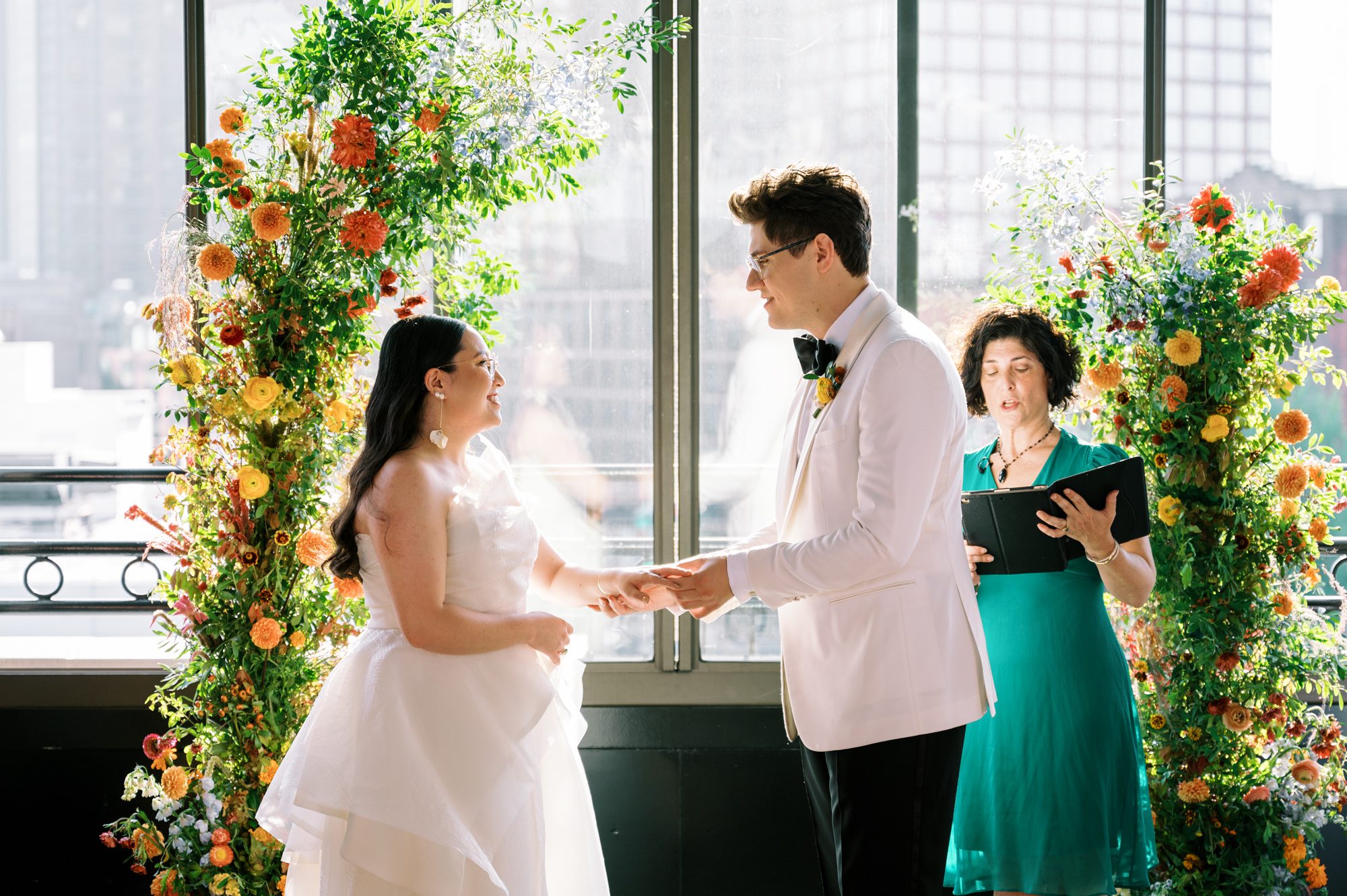 So excited for Erika and Andrei’s wedding day at The Box House Hotel in Brooklyn, NY. This boutique hotel had been on my bucket list for a while, and it did not disappoint! With its unique design, vibrant personality, and incredible rooftop views, The Box House Hotel provided the perfect setting for unique wedding celebration.
The day began with Erika and Andrei getting ready in their respective rooms, surrounded by friends and loved ones. One of the standout features of The Box House Hotel is its boutique charm and eclectic style, blending industrial elements with a cozy, artistic vibe. Erika’s bridal suite, with its floor-to-ceiling windows, was filled with natural light, making it a dream space for capturing those intimate getting-ready moments.
Once everyone was ready, Andrei headed to the rooftop, eagerly waiting to see his bride for the first time. As Erika gracefully approached, her dress swaying in the breeze, Andrei turned around, completely captivated. The two shared a private, heartfelt moment, whispering sweet words to each other, before we moved on to family photos.
The Box House Hotel’s location on a quiet Brooklyn street was perfect for photos. We captured their formal family and bridal party shots right in front of the hotel, showcasing its charming exterior. Then came a unique tradition I’d never witnessed before in my 14+ years of wedding photography! Erika and Andrei brought out a bucket of water filled with coins, and as guests cheered, Erika kicked the bucket as far as she could—a cultural ritual symbolizing good luck and prosperity. It was a joy to photograph and such a fun, memorable moment!
Afterward, we made our way back to the 10,000-square-foot rooftop, which offers unparalleled panoramic views of Manhattan, Brooklyn, and Long Island City. It’s a breathtaking setting for any wedding, leaving guests in awe of the skyline. Friends and family traveled from near and far, including Japan and Romania, to celebrate Erika and Andrei. To honor Erika's Japanese roots, Erika and Andrei incorporated a Japanese tea ceremony officiated by Erika's cousins from Japan. The rooftop was filled with laughter, love, and joy as the ceremony unfolded under the open sky.
As the sun set, the magic of the evening truly came alive. The city skyline twinkled with lights, and the dark sky sparkled with stars. Erika and Andrei danced, laughed, and celebrated late into the night, surrounded by their closest friends and family.
The Box House Hotel is a one-of-a-kind venue, blending urban sophistication with artistic charm. Its rooftop views, boutique-style accommodations, and vibrant atmosphere make it a perfect choice for couples looking to create a unique and unforgettable wedding experience.
Erika and Andrei, thank you for letting me be part of your incredible day. Wishing you a lifetime of love, happiness, and adventure!
Erika and Andrei The Box House Hotel Brooklyn NY Wedding documented by Karis from Hey Karis New York, Brooklyn, Hudson Valley NY and Catskills NY and NJ Wedding and NYC Elopement Photographer.