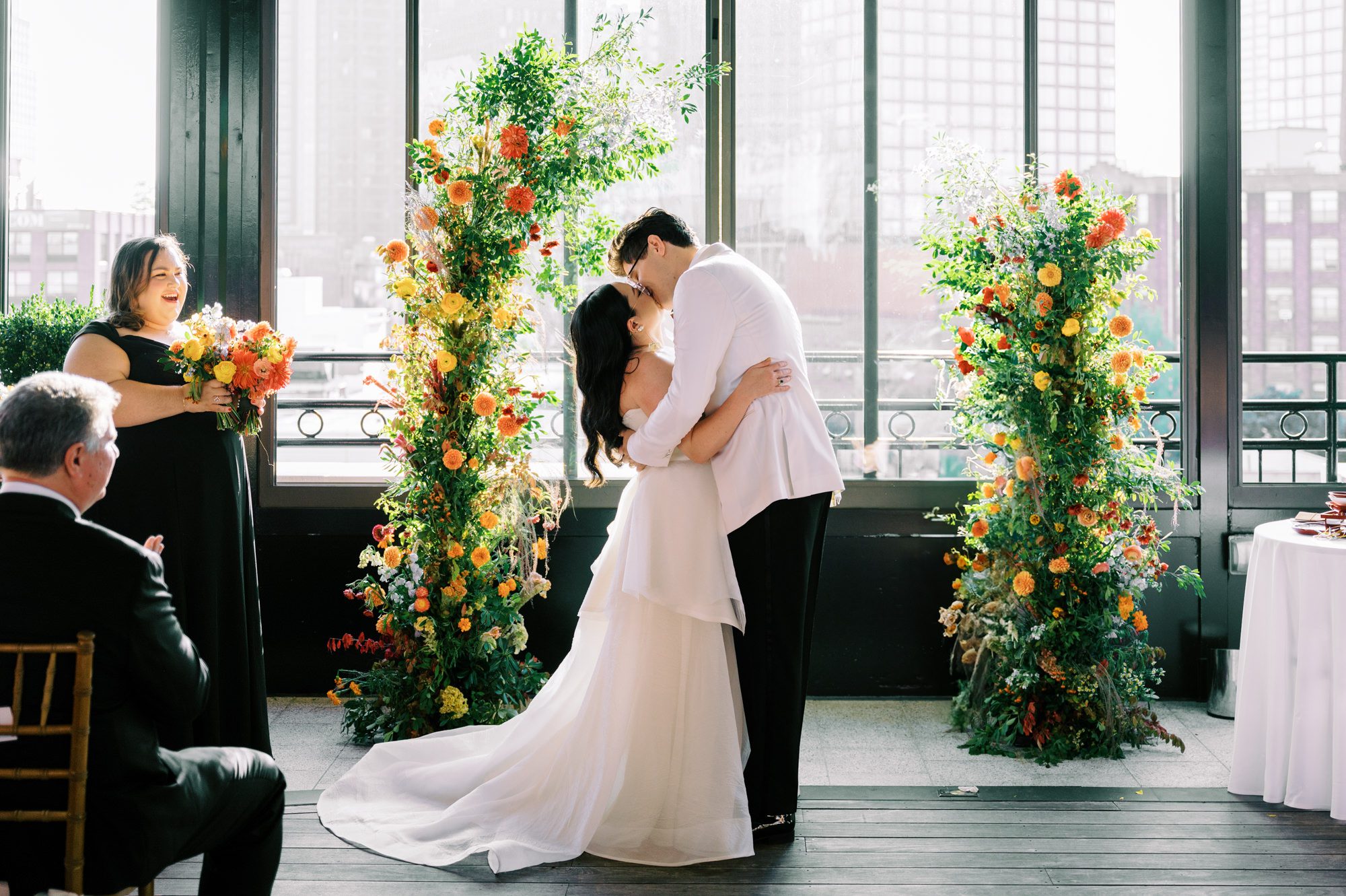 So excited for Erika and Andrei’s wedding day at The Box House Hotel in Brooklyn, NY. This boutique hotel had been on my bucket list for a while, and it did not disappoint! With its unique design, vibrant personality, and incredible rooftop views, The Box House Hotel provided the perfect setting for unique wedding celebration.
The day began with Erika and Andrei getting ready in their respective rooms, surrounded by friends and loved ones. One of the standout features of The Box House Hotel is its boutique charm and eclectic style, blending industrial elements with a cozy, artistic vibe. Erika’s bridal suite, with its floor-to-ceiling windows, was filled with natural light, making it a dream space for capturing those intimate getting-ready moments.
Once everyone was ready, Andrei headed to the rooftop, eagerly waiting to see his bride for the first time. As Erika gracefully approached, her dress swaying in the breeze, Andrei turned around, completely captivated. The two shared a private, heartfelt moment, whispering sweet words to each other, before we moved on to family photos.
The Box House Hotel’s location on a quiet Brooklyn street was perfect for photos. We captured their formal family and bridal party shots right in front of the hotel, showcasing its charming exterior. Then came a unique tradition I’d never witnessed before in my 14+ years of wedding photography! Erika and Andrei brought out a bucket of water filled with coins, and as guests cheered, Erika kicked the bucket as far as she could—a cultural ritual symbolizing good luck and prosperity. It was a joy to photograph and such a fun, memorable moment!
Afterward, we made our way back to the 10,000-square-foot rooftop, which offers unparalleled panoramic views of Manhattan, Brooklyn, and Long Island City. It’s a breathtaking setting for any wedding, leaving guests in awe of the skyline. Friends and family traveled from near and far, including Japan and Romania, to celebrate Erika and Andrei. To honor Erika's Japanese roots, Erika and Andrei incorporated a Japanese tea ceremony officiated by Erika's cousins from Japan. The rooftop was filled with laughter, love, and joy as the ceremony unfolded under the open sky.
As the sun set, the magic of the evening truly came alive. The city skyline twinkled with lights, and the dark sky sparkled with stars. Erika and Andrei danced, laughed, and celebrated late into the night, surrounded by their closest friends and family.
The Box House Hotel is a one-of-a-kind venue, blending urban sophistication with artistic charm. Its rooftop views, boutique-style accommodations, and vibrant atmosphere make it a perfect choice for couples looking to create a unique and unforgettable wedding experience.
Erika and Andrei, thank you for letting me be part of your incredible day. Wishing you a lifetime of love, happiness, and adventure!
Erika and Andrei The Box House Hotel Brooklyn NY Wedding documented by Karis from Hey Karis New York, Brooklyn, Hudson Valley NY and Catskills NY and NJ Wedding and NYC Elopement Photographer.