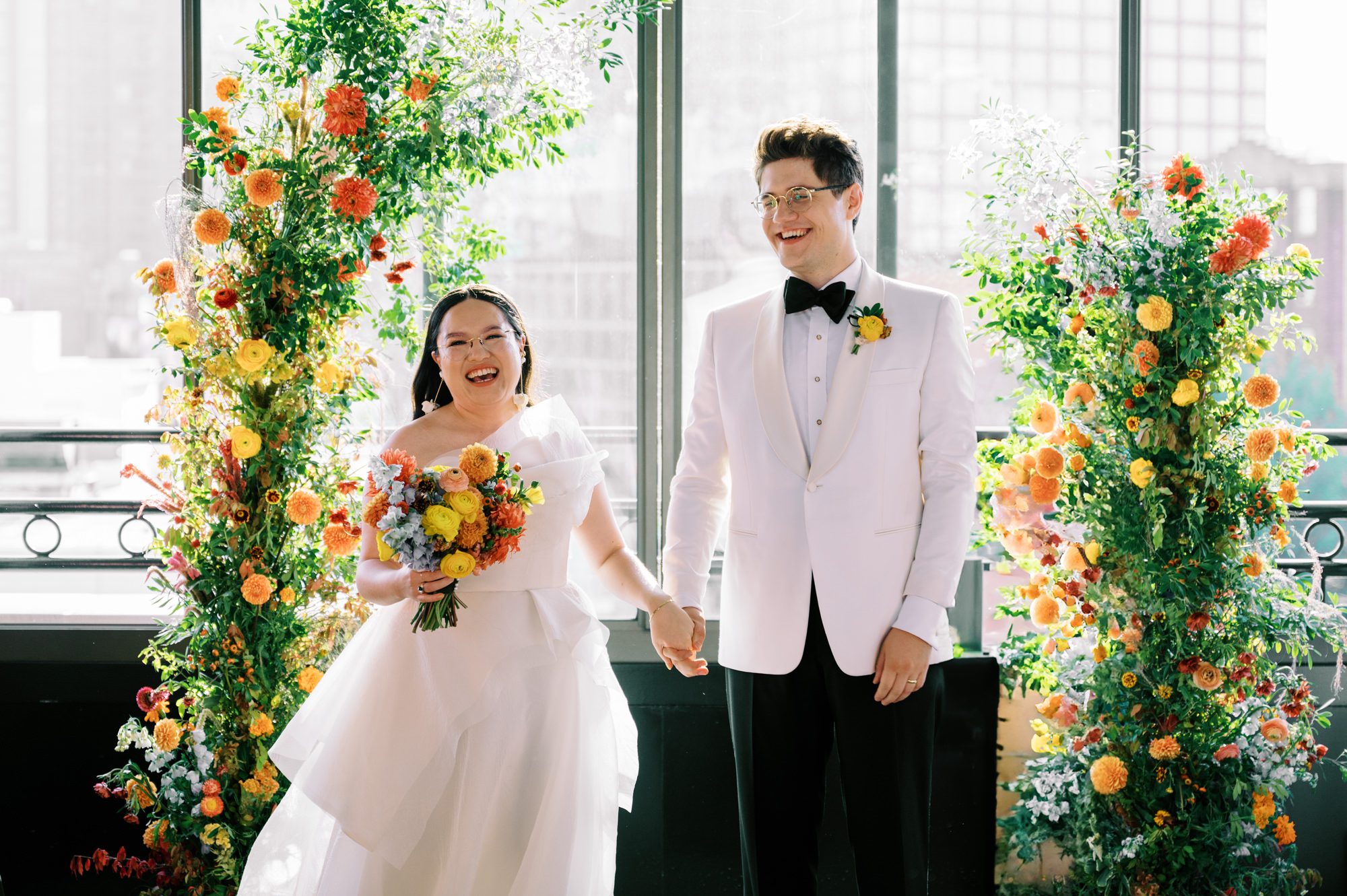 So excited for Erika and Andrei’s wedding day at The Box House Hotel in Brooklyn, NY. This boutique hotel had been on my bucket list for a while, and it did not disappoint! With its unique design, vibrant personality, and incredible rooftop views, The Box House Hotel provided the perfect setting for unique wedding celebration.
The day began with Erika and Andrei getting ready in their respective rooms, surrounded by friends and loved ones. One of the standout features of The Box House Hotel is its boutique charm and eclectic style, blending industrial elements with a cozy, artistic vibe. Erika’s bridal suite, with its floor-to-ceiling windows, was filled with natural light, making it a dream space for capturing those intimate getting-ready moments.
Once everyone was ready, Andrei headed to the rooftop, eagerly waiting to see his bride for the first time. As Erika gracefully approached, her dress swaying in the breeze, Andrei turned around, completely captivated. The two shared a private, heartfelt moment, whispering sweet words to each other, before we moved on to family photos.
The Box House Hotel’s location on a quiet Brooklyn street was perfect for photos. We captured their formal family and bridal party shots right in front of the hotel, showcasing its charming exterior. Then came a unique tradition I’d never witnessed before in my 14+ years of wedding photography! Erika and Andrei brought out a bucket of water filled with coins, and as guests cheered, Erika kicked the bucket as far as she could—a cultural ritual symbolizing good luck and prosperity. It was a joy to photograph and such a fun, memorable moment!
Afterward, we made our way back to the 10,000-square-foot rooftop, which offers unparalleled panoramic views of Manhattan, Brooklyn, and Long Island City. It’s a breathtaking setting for any wedding, leaving guests in awe of the skyline. Friends and family traveled from near and far, including Japan and Romania, to celebrate Erika and Andrei. To honor Erika's Japanese roots, Erika and Andrei incorporated a Japanese tea ceremony officiated by Erika's cousins from Japan. The rooftop was filled with laughter, love, and joy as the ceremony unfolded under the open sky.
As the sun set, the magic of the evening truly came alive. The city skyline twinkled with lights, and the dark sky sparkled with stars. Erika and Andrei danced, laughed, and celebrated late into the night, surrounded by their closest friends and family.
The Box House Hotel is a one-of-a-kind venue, blending urban sophistication with artistic charm. Its rooftop views, boutique-style accommodations, and vibrant atmosphere make it a perfect choice for couples looking to create a unique and unforgettable wedding experience.
Erika and Andrei, thank you for letting me be part of your incredible day. Wishing you a lifetime of love, happiness, and adventure!
Erika and Andrei The Box House Hotel Brooklyn NY Wedding documented by Karis from Hey Karis New York, Brooklyn, Hudson Valley NY and Catskills NY and NJ Wedding and NYC Elopement Photographer.