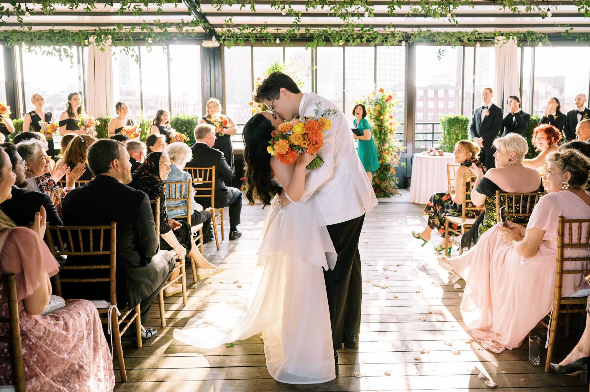 So excited for Erika and Andrei’s wedding day at The Box House Hotel in Brooklyn, NY. This boutique hotel had been on my bucket list for a while, and it did not disappoint! With its unique design, vibrant personality, and incredible rooftop views, The Box House Hotel provided the perfect setting for unique wedding celebration.
The day began with Erika and Andrei getting ready in their respective rooms, surrounded by friends and loved ones. One of the standout features of The Box House Hotel is its boutique charm and eclectic style, blending industrial elements with a cozy, artistic vibe. Erika’s bridal suite, with its floor-to-ceiling windows, was filled with natural light, making it a dream space for capturing those intimate getting-ready moments.
Once everyone was ready, Andrei headed to the rooftop, eagerly waiting to see his bride for the first time. As Erika gracefully approached, her dress swaying in the breeze, Andrei turned around, completely captivated. The two shared a private, heartfelt moment, whispering sweet words to each other, before we moved on to family photos.
The Box House Hotel’s location on a quiet Brooklyn street was perfect for photos. We captured their formal family and bridal party shots right in front of the hotel, showcasing its charming exterior. Then came a unique tradition I’d never witnessed before in my 14+ years of wedding photography! Erika and Andrei brought out a bucket of water filled with coins, and as guests cheered, Erika kicked the bucket as far as she could—a cultural ritual symbolizing good luck and prosperity. It was a joy to photograph and such a fun, memorable moment!
Afterward, we made our way back to the 10,000-square-foot rooftop, which offers unparalleled panoramic views of Manhattan, Brooklyn, and Long Island City. It’s a breathtaking setting for any wedding, leaving guests in awe of the skyline. Friends and family traveled from near and far, including Japan and Romania, to celebrate Erika and Andrei. To honor Erika's Japanese roots, Erika and Andrei incorporated a Japanese tea ceremony officiated by Erika's cousins from Japan. The rooftop was filled with laughter, love, and joy as the ceremony unfolded under the open sky.
As the sun set, the magic of the evening truly came alive. The city skyline twinkled with lights, and the dark sky sparkled with stars. Erika and Andrei danced, laughed, and celebrated late into the night, surrounded by their closest friends and family.
The Box House Hotel is a one-of-a-kind venue, blending urban sophistication with artistic charm. Its rooftop views, boutique-style accommodations, and vibrant atmosphere make it a perfect choice for couples looking to create a unique and unforgettable wedding experience.
Erika and Andrei, thank you for letting me be part of your incredible day. Wishing you a lifetime of love, happiness, and adventure!
Erika and Andrei The Box House Hotel Brooklyn NY Wedding documented by Karis from Hey Karis New York, Brooklyn, Hudson Valley NY and Catskills NY and NJ Wedding and NYC Elopement Photographer.