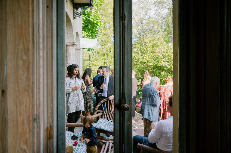 Driving up the long, tree-lined driveway to Arrow Park is a magical experience. No matter how many times you see it, the peaceful serenity of the surroundings leaves you in awe. On Willa and Alex’s wedding day, the forecast called for heavy overcast skies, which only made the lush greenery more vibrant. As I approached the historic mansion, a light rain began to fall, making the natural landscape look even more alive and enchanting.
Inside the mansion, the atmosphere was festive and filled with excitement. I spotted Alex bustling around, finishing some light tasks with a mix of nervous energy and anticipation. On the third floor, I found Willa glowing with happiness as she admired herself in the mirror in her wedding dress. After her final look, Willa gracefully descended the grand staircase to the terrace, where Alex was waiting for their first look.
Despite the gentle drizzle, the terrace offered the perfect backdrop for this intimate moment. Framed by Arrow Park’s lush greenery and timeless charm, Willa and Alex exchanged private vows. It was a sweet, emotional moment, just the two of them, soaking in the beauty of the day before heading back into the mansion.
Arrow Park, with its 1920s-era mansion, sprawling grounds, and serene lakefront, is a venue that seamlessly combines natural beauty with historical elegance. It’s a place that feels worlds away while still being accessible, making it ideal for couples who want a tranquil yet sophisticated setting for their wedding day.
Willa and Alex wanted their wedding to focus on spending quality time with their loved ones rather than being tied to posed portraits. As a result, nearly the entire day was filled with organic, documentary-style moments that were both refreshing and liberating to capture.
Their Jewish ceremony was held on the terrace, with Arrow Park’s picturesque grounds as the backdrop. One of the most unique elements of their ceremony was the participation of friends and family in the Seven Blessings, a beautiful and meaningful tradition that added a personal touch to their day.
During cocktail hour, Willa and Alex mingled effortlessly with their guests, catching up with family and friends they hadn’t seen in some time. Afterward, the celebration moved to the rustic lodge, a space that perfectly complements Arrow Park’s vintage charm. The lodge was alive with dancing, singing, and laughter as Willa and Alex celebrated the start of their new chapter, surrounded by their closest family and friends.
Willa and Alex’s wedding at Arrow Park was a day filled with love, joy, and meaningful connections. It was an honor to document such a heartfelt celebration in one of the most breathtaking venues in New York. Congratulations, Willa and Alex!
Willa and Alex Arrow Park NY Wedding documented by Karis from Hey Karis New York, Brooklyn, Hudson Valley NY and Catskills NY and NJ Wedding and NYC Elopement Photographer.
