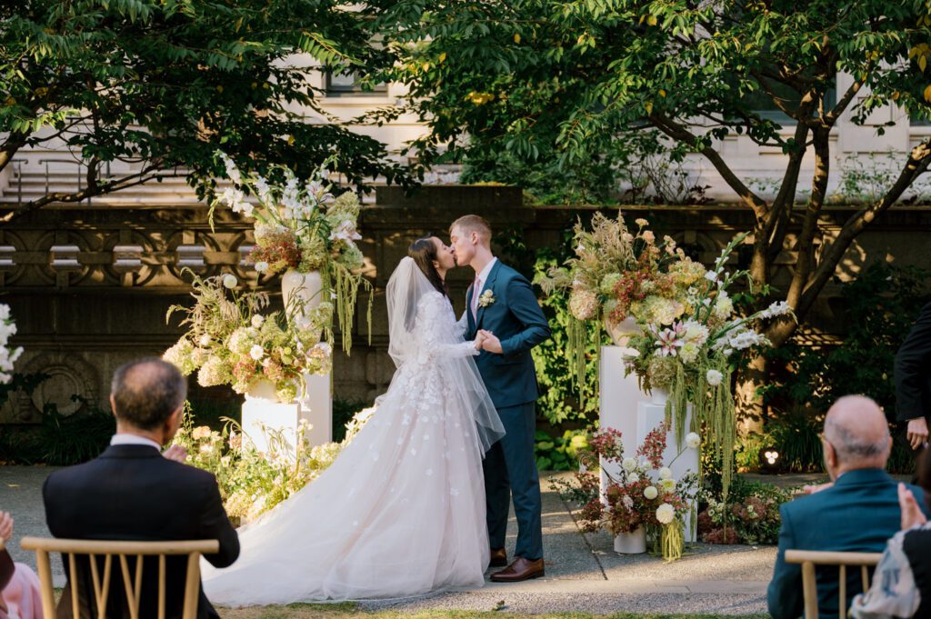 Gorgeous September Wedding at Cooper Hewitt, Smithsonian Design Museum in Manhattan, NY
The breathtaking lawn at the Cooper Hewitt was adorned with a stunning tent and lush greenery. Matching tablecloths and elegant dinnerware were set beneath the tent, creating a sophisticated ambiance. The garden was transformed into a beautiful ceremony space in the heart of Manhattan. Surrounded by towering buildings, it felt almost surreal—a peaceful oasis in the city.
The clinking of champagne glasses and trays of hors d'oeuvres added to the joyous atmosphere as guests savored every moment of the cocktail hour. When the sky darkened, guests moved under the tent for the reception. As night fell, the glow of the candles became warmer and brighter, creating an enchanting setting. The sound of lively conversation and laughter filled the Manhattan air.
Dancing took place inside the historic Cooper Hewitt mansion, where the live band, On The Move Events, delivered an unforgettable performance. Guests enthusiastically filled the dance floor, ending the evening on a high note of celebration and joy.
Thankful for all the wedding vendors that made this day possible:
Planner: @aniwolff_⁠
Venue: @cooperhewitt
Catering: @thomaspretieventstosavor
Tent: @stamford_tent
Lighting: @frostproductionsnyc⁠
Rentals: @sdpr_rentals⁠
Linens: @nuagedesignsinc⁠
Photographer: @heykaris
Videographer: @katiarepinafilms⁠
Florist: @sarahsaundersstudio
Entertainment: @onthemoveevents⁠
Cake: @luckybirdcakes⁠
Officiant: @ourweddingofficiantnyc⁠
Ceremony Strings: @impulsestrings⁠
Stationery: @jensimpsondesign⁠
Favors: @swmsweets
Cooper Hewitt Smithsonian Design Museum Manhattan NY Wedding documented by Karis from Hey Karis New York, Brooklyn, Hudson Valley NY and Catskills NY and NJ Wedding and NYC Elopement Photographer.