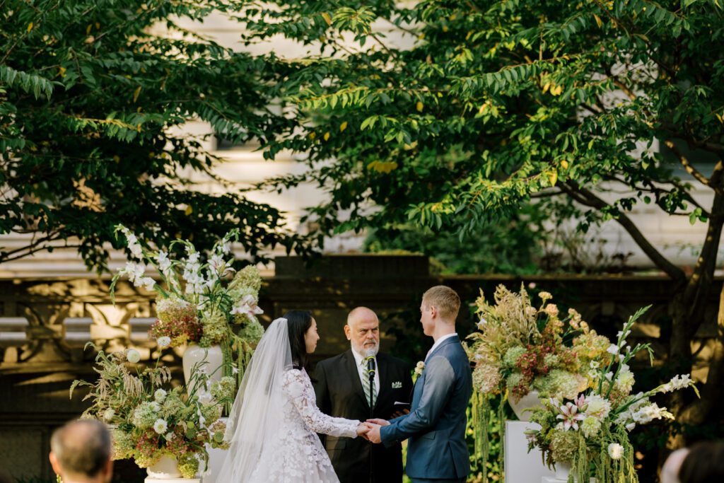 Gorgeous September Wedding at Cooper Hewitt, Smithsonian Design Museum in Manhattan, NY
The breathtaking lawn at the Cooper Hewitt was adorned with a stunning tent and lush greenery. Matching tablecloths and elegant dinnerware were set beneath the tent, creating a sophisticated ambiance. The garden was transformed into a beautiful ceremony space in the heart of Manhattan. Surrounded by towering buildings, it felt almost surreal—a peaceful oasis in the city.
The clinking of champagne glasses and trays of hors d'oeuvres added to the joyous atmosphere as guests savored every moment of the cocktail hour. When the sky darkened, guests moved under the tent for the reception. As night fell, the glow of the candles became warmer and brighter, creating an enchanting setting. The sound of lively conversation and laughter filled the Manhattan air.
Dancing took place inside the historic Cooper Hewitt mansion, where the live band, On The Move Events, delivered an unforgettable performance. Guests enthusiastically filled the dance floor, ending the evening on a high note of celebration and joy.
Thankful for all the wedding vendors that made this day possible:
Planner: @aniwolff_⁠
Venue: @cooperhewitt
Catering: @thomaspretieventstosavor
Tent: @stamford_tent
Lighting: @frostproductionsnyc⁠
Rentals: @sdpr_rentals⁠
Linens: @nuagedesignsinc⁠
Photographer: @heykaris
Videographer: @katiarepinafilms⁠
Florist: @sarahsaundersstudio
Entertainment: @onthemoveevents⁠
Cake: @luckybirdcakes⁠
Officiant: @ourweddingofficiantnyc⁠
Ceremony Strings: @impulsestrings⁠
Stationery: @jensimpsondesign⁠
Favors: @swmsweets
Cooper Hewitt Smithsonian Design Museum Manhattan NY Wedding documented by Karis from Hey Karis New York, Brooklyn, Hudson Valley NY and Catskills NY and NJ Wedding and NYC Elopement Photographer.