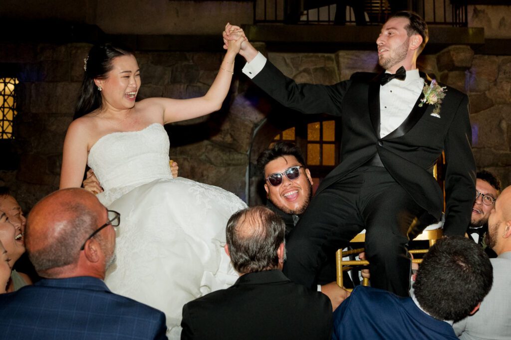 Vivian and Josh’s Gorgeous September Wedding at Arrow Park, NY
There’s something truly special about Arrow Park—it feels like my home away from home, and Vivian and Josh’s beautiful September wedding perfectly showcased everything this venue has to offer. Their blended celebration, honoring Vivian’s Korean heritage and Josh’s Jewish background, was a heartfelt and unforgettable day.
The couple beautifully wove their cultures into the festivities, from breaking the glass at the end of their garden ceremony to the lively horah during the reception. Later, Vivian and Josh delighted their guests by changing into traditional Korean hanbok outfits, a touching nod to her heritage.
Arrow Park: A Dream Venue for Multi-Day WeddingsVivian, Josh, and their loved ones all got ready at Arrow Park, which offers plenty of spacious accommodations for family and friends. This made it the perfect choice for their multi-day celebration. With its stunning grounds and versatile spaces, Arrow Park is ideal for couples seeking a wedding weekend filled with both elegance and comfort.
A Scenic September CelebrationThanks to the pleasant September weather, Vivian and Josh made full use of Arrow Park’s breathtaking grounds. Their day began with a magical first look along the iconic driveway lined with towering trees. From there, we explored the garden with its charming sculptures, captured moments by the ceremony’s floral décor, and took stunning portraits on the mansion’s iconic back staircase bathed in perfect lighting. We also ventured indoors for photos in the library and the Green Room, taking advantage of the mansion’s timeless charm.
As family and friends gathered, we captured formal portraits in front of the grand mansion before the ceremony began.
A Ceremony and Reception to RememberThe ceremony was set in the picturesque garden, where Jenny from Field Trip Flowers created a breathtaking floral backdrop that perfectly complemented the natural beauty of Arrow Park.
Afterward, guests strolled back to the mansion for a warm and inviting cocktail hour on the main floor. Later, everyone gathered in the courtyard for an enchanting outdoor reception under twinkling café lights. The space felt intimate yet grand, with the perfect blend of rustic elegance and romance.
Arrow Park’s charm, coupled with Vivian and Josh’s thoughtful cultural details, made this wedding one to remember. It’s the kind of venue where dreams come true—a hidden gem that’s ready to host your perfect day.
  
Thankful for all the wedding vendors that made this day possible:⁠
Venue: @arrowparkny
Floral: @fieldtripflowers

Vivian and Josh Arrow Park NY Wedding documented by Karis from Hey Karis New York, Brooklyn, Hudson Valley NY and Catskills NY and NJ Wedding and NYC Elopement Photographer.