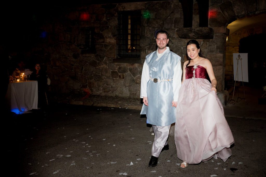 Vivian and Josh’s Gorgeous September Wedding at Arrow Park, NY
There’s something truly special about Arrow Park—it feels like my home away from home, and Vivian and Josh’s beautiful September wedding perfectly showcased everything this venue has to offer. Their blended celebration, honoring Vivian’s Korean heritage and Josh’s Jewish background, was a heartfelt and unforgettable day.
The couple beautifully wove their cultures into the festivities, from breaking the glass at the end of their garden ceremony to the lively horah during the reception. Later, Vivian and Josh delighted their guests by changing into traditional Korean hanbok outfits, a touching nod to her heritage.
Arrow Park: A Dream Venue for Multi-Day WeddingsVivian, Josh, and their loved ones all got ready at Arrow Park, which offers plenty of spacious accommodations for family and friends. This made it the perfect choice for their multi-day celebration. With its stunning grounds and versatile spaces, Arrow Park is ideal for couples seeking a wedding weekend filled with both elegance and comfort.
A Scenic September CelebrationThanks to the pleasant September weather, Vivian and Josh made full use of Arrow Park’s breathtaking grounds. Their day began with a magical first look along the iconic driveway lined with towering trees. From there, we explored the garden with its charming sculptures, captured moments by the ceremony’s floral décor, and took stunning portraits on the mansion’s iconic back staircase bathed in perfect lighting. We also ventured indoors for photos in the library and the Green Room, taking advantage of the mansion’s timeless charm.
As family and friends gathered, we captured formal portraits in front of the grand mansion before the ceremony began.
A Ceremony and Reception to RememberThe ceremony was set in the picturesque garden, where Jenny from Field Trip Flowers created a breathtaking floral backdrop that perfectly complemented the natural beauty of Arrow Park.
Afterward, guests strolled back to the mansion for a warm and inviting cocktail hour on the main floor. Later, everyone gathered in the courtyard for an enchanting outdoor reception under twinkling café lights. The space felt intimate yet grand, with the perfect blend of rustic elegance and romance.
Arrow Park’s charm, coupled with Vivian and Josh’s thoughtful cultural details, made this wedding one to remember. It’s the kind of venue where dreams come true—a hidden gem that’s ready to host your perfect day.
  
Thankful for all the wedding vendors that made this day possible:⁠
Venue: @arrowparkny
Floral: @fieldtripflowers

Vivian and Josh Arrow Park NY Wedding documented by Karis from Hey Karis New York, Brooklyn, Hudson Valley NY and Catskills NY and NJ Wedding and NYC Elopement Photographer.
