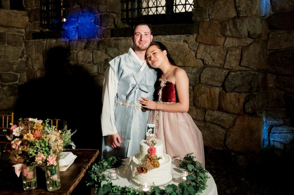 Vivian and Josh’s Gorgeous September Wedding at Arrow Park, NY
There’s something truly special about Arrow Park—it feels like my home away from home, and Vivian and Josh’s beautiful September wedding perfectly showcased everything this venue has to offer. Their blended celebration, honoring Vivian’s Korean heritage and Josh’s Jewish background, was a heartfelt and unforgettable day.
The couple beautifully wove their cultures into the festivities, from breaking the glass at the end of their garden ceremony to the lively horah during the reception. Later, Vivian and Josh delighted their guests by changing into traditional Korean hanbok outfits, a touching nod to her heritage.
Arrow Park: A Dream Venue for Multi-Day WeddingsVivian, Josh, and their loved ones all got ready at Arrow Park, which offers plenty of spacious accommodations for family and friends. This made it the perfect choice for their multi-day celebration. With its stunning grounds and versatile spaces, Arrow Park is ideal for couples seeking a wedding weekend filled with both elegance and comfort.
A Scenic September CelebrationThanks to the pleasant September weather, Vivian and Josh made full use of Arrow Park’s breathtaking grounds. Their day began with a magical first look along the iconic driveway lined with towering trees. From there, we explored the garden with its charming sculptures, captured moments by the ceremony’s floral décor, and took stunning portraits on the mansion’s iconic back staircase bathed in perfect lighting. We also ventured indoors for photos in the library and the Green Room, taking advantage of the mansion’s timeless charm.
As family and friends gathered, we captured formal portraits in front of the grand mansion before the ceremony began.
A Ceremony and Reception to RememberThe ceremony was set in the picturesque garden, where Jenny from Field Trip Flowers created a breathtaking floral backdrop that perfectly complemented the natural beauty of Arrow Park.
Afterward, guests strolled back to the mansion for a warm and inviting cocktail hour on the main floor. Later, everyone gathered in the courtyard for an enchanting outdoor reception under twinkling café lights. The space felt intimate yet grand, with the perfect blend of rustic elegance and romance.
Arrow Park’s charm, coupled with Vivian and Josh’s thoughtful cultural details, made this wedding one to remember. It’s the kind of venue where dreams come true—a hidden gem that’s ready to host your perfect day.
  
Thankful for all the wedding vendors that made this day possible:⁠
Venue: @arrowparkny
Floral: @fieldtripflowers

Vivian and Josh Arrow Park NY Wedding documented by Karis from Hey Karis New York, Brooklyn, Hudson Valley NY and Catskills NY and NJ Wedding and NYC Elopement Photographer.