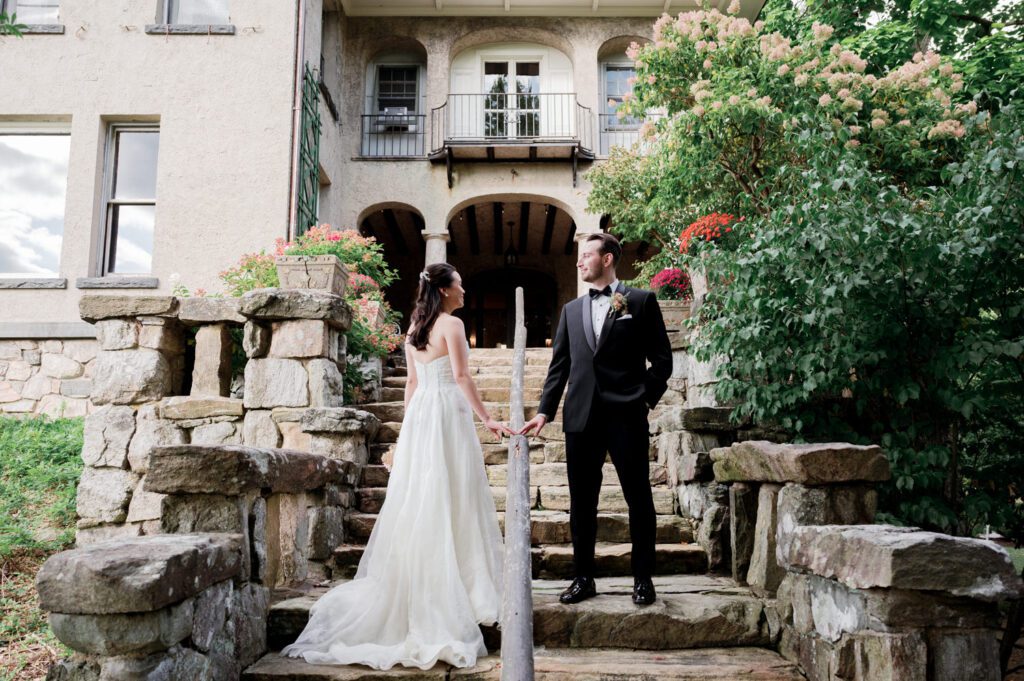 Vivian and Josh’s Gorgeous September Wedding at Arrow Park, NY
There’s something truly special about Arrow Park—it feels like my home away from home, and Vivian and Josh’s beautiful September wedding perfectly showcased everything this venue has to offer. Their blended celebration, honoring Vivian’s Korean heritage and Josh’s Jewish background, was a heartfelt and unforgettable day.
The couple beautifully wove their cultures into the festivities, from breaking the glass at the end of their garden ceremony to the lively horah during the reception. Later, Vivian and Josh delighted their guests by changing into traditional Korean hanbok outfits, a touching nod to her heritage.
Arrow Park: A Dream Venue for Multi-Day WeddingsVivian, Josh, and their loved ones all got ready at Arrow Park, which offers plenty of spacious accommodations for family and friends. This made it the perfect choice for their multi-day celebration. With its stunning grounds and versatile spaces, Arrow Park is ideal for couples seeking a wedding weekend filled with both elegance and comfort.
A Scenic September CelebrationThanks to the pleasant September weather, Vivian and Josh made full use of Arrow Park’s breathtaking grounds. Their day began with a magical first look along the iconic driveway lined with towering trees. From there, we explored the garden with its charming sculptures, captured moments by the ceremony’s floral décor, and took stunning portraits on the mansion’s iconic back staircase bathed in perfect lighting. We also ventured indoors for photos in the library and the Green Room, taking advantage of the mansion’s timeless charm.
As family and friends gathered, we captured formal portraits in front of the grand mansion before the ceremony began.
A Ceremony and Reception to RememberThe ceremony was set in the picturesque garden, where Jenny from Field Trip Flowers created a breathtaking floral backdrop that perfectly complemented the natural beauty of Arrow Park.
Afterward, guests strolled back to the mansion for a warm and inviting cocktail hour on the main floor. Later, everyone gathered in the courtyard for an enchanting outdoor reception under twinkling café lights. The space felt intimate yet grand, with the perfect blend of rustic elegance and romance.
Arrow Park’s charm, coupled with Vivian and Josh’s thoughtful cultural details, made this wedding one to remember. It’s the kind of venue where dreams come true—a hidden gem that’s ready to host your perfect day.
  
Thankful for all the wedding vendors that made this day possible:⁠
Venue: @arrowparkny
Floral: @fieldtripflowers
Catering: @lovenrosemary

Vivian and Josh Arrow Park NY Wedding documented by Karis from Hey Karis New York, Brooklyn, Hudson Valley NY and Catskills NY and NJ Wedding and NYC Elopement Photographer.